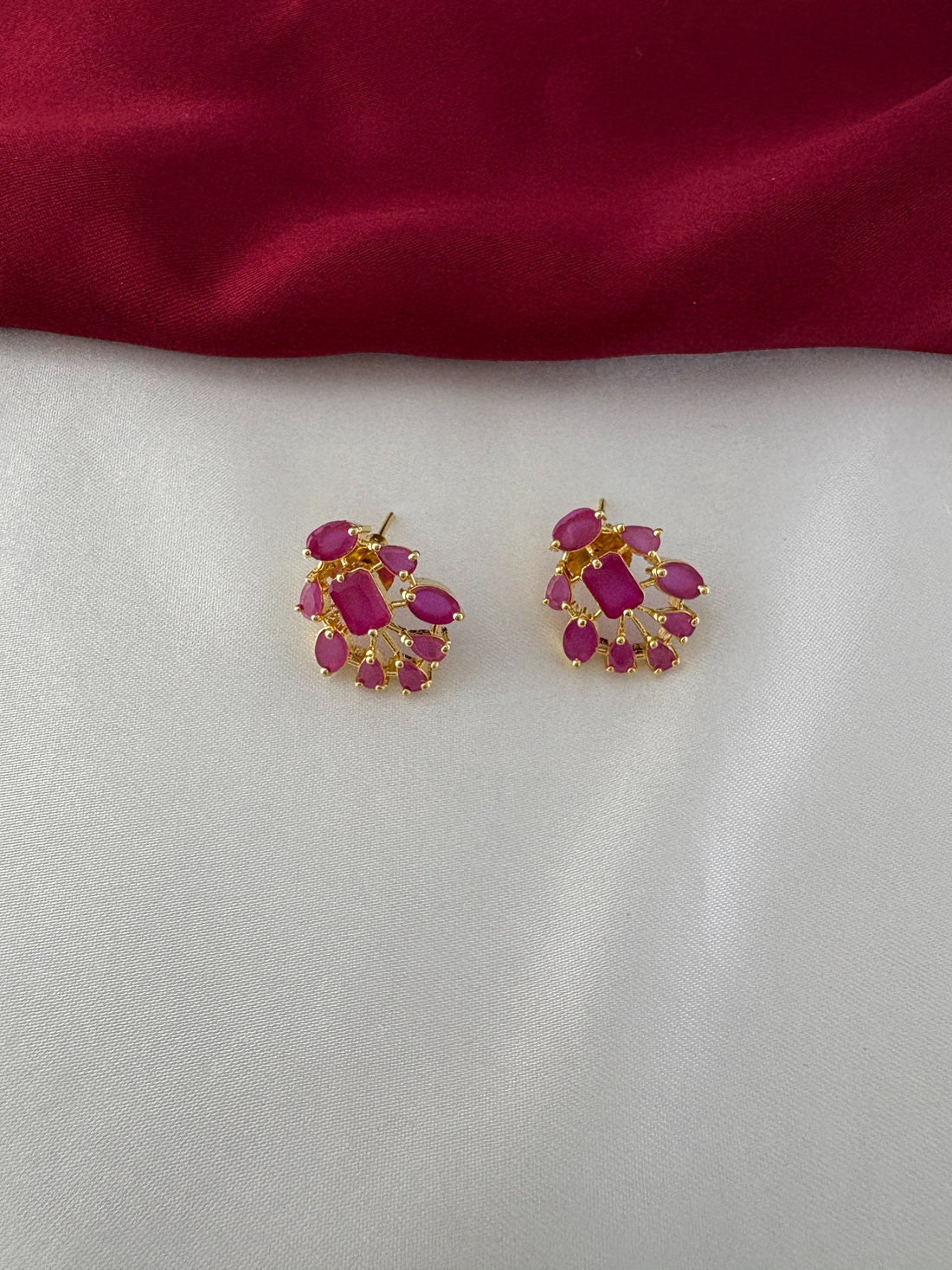FeelOri Gold Plated Ruby Petal Earrings - Close-up view of the clustered ruby-hued stones set in a fan-like design, highlighting their intricate detail.