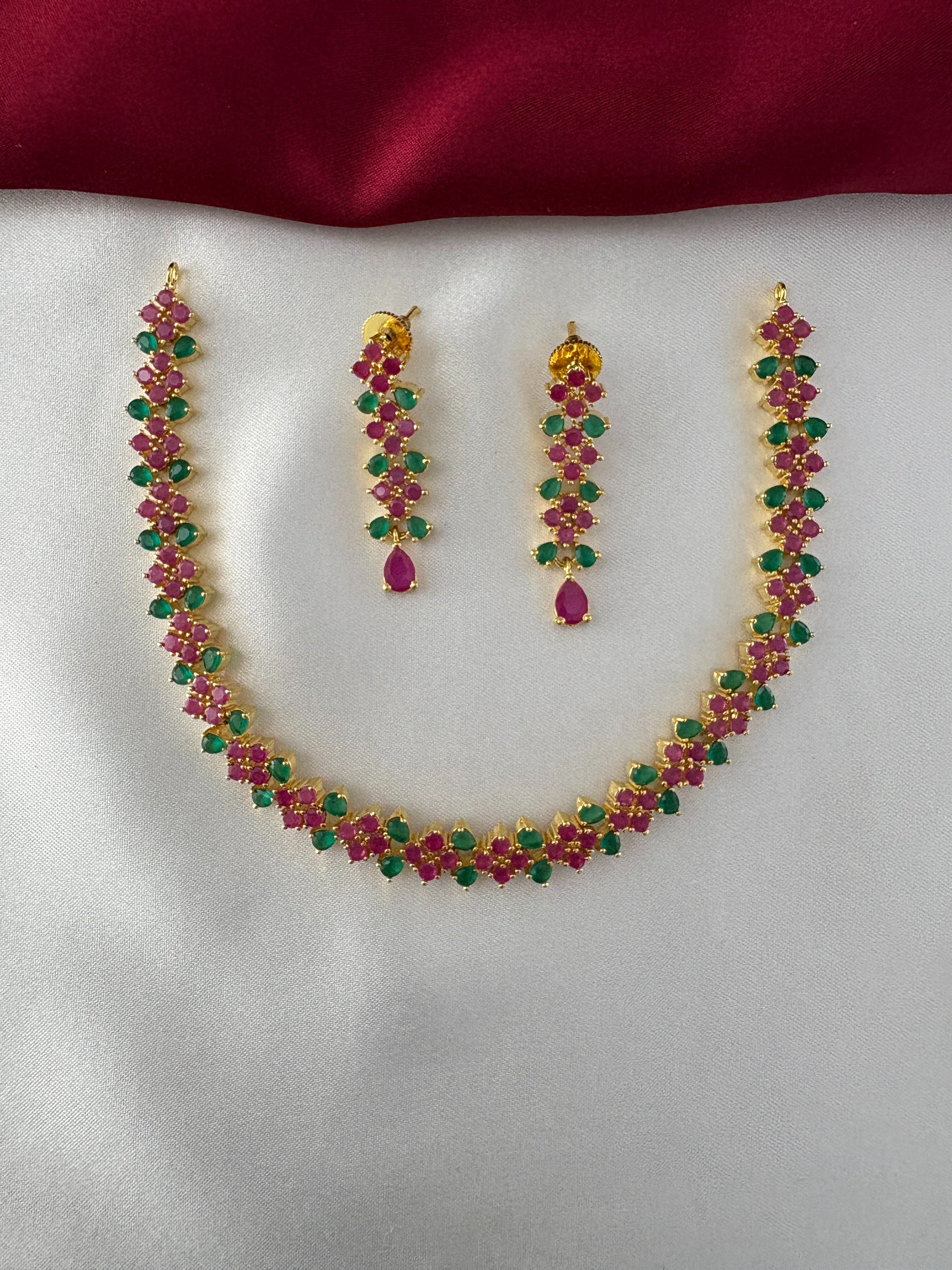 FeelOri Gold Plated Ruby Emerald Leaf Strand Jewelry Set - Full view of the necklace and matching earrings showcasing the continuous leaf motif.