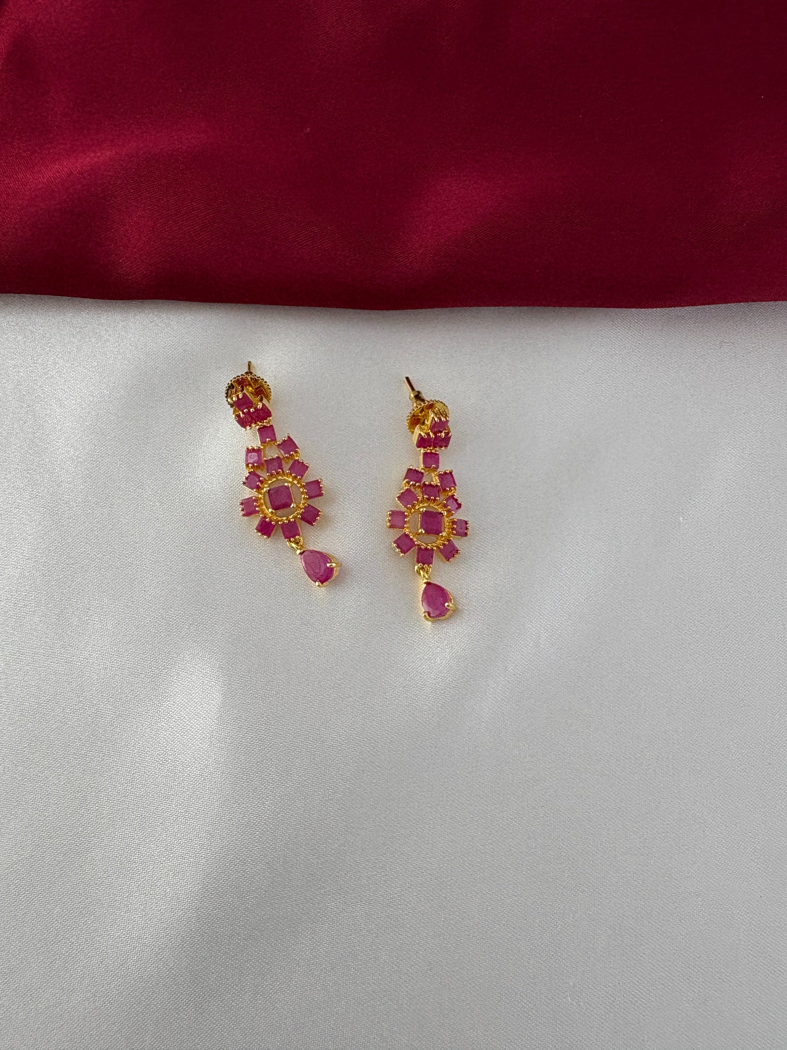 FeelOri Gold Plated Ruby Floral Earrings - Close-up view highlighting the intricate flower arrangement and dangling ruby-hued teardrop design.