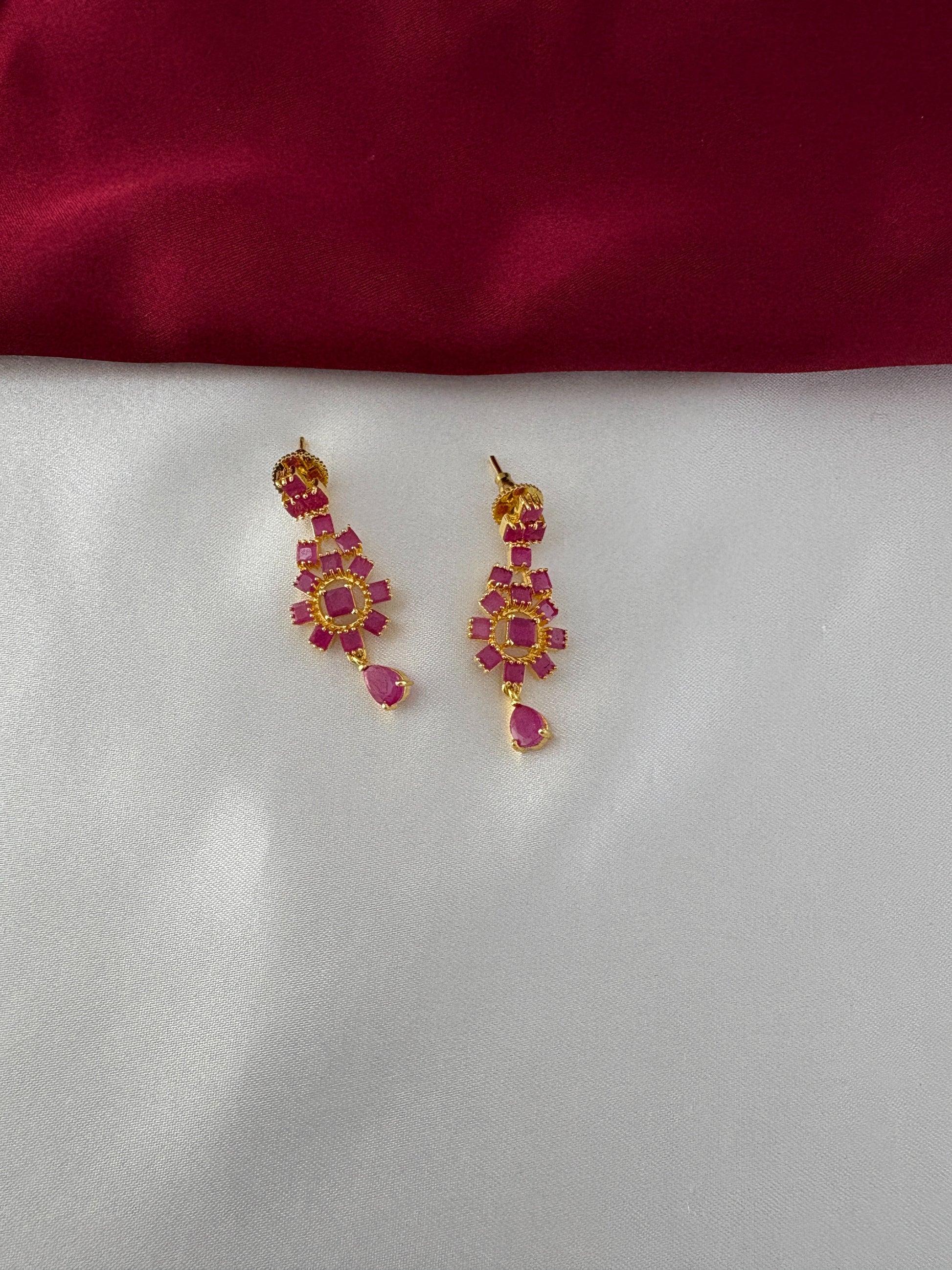 FeelOri Gold Plated Ruby Floral Earrings - Close-up view highlighting the intricate flower arrangement and dangling ruby-hued teardrop design.