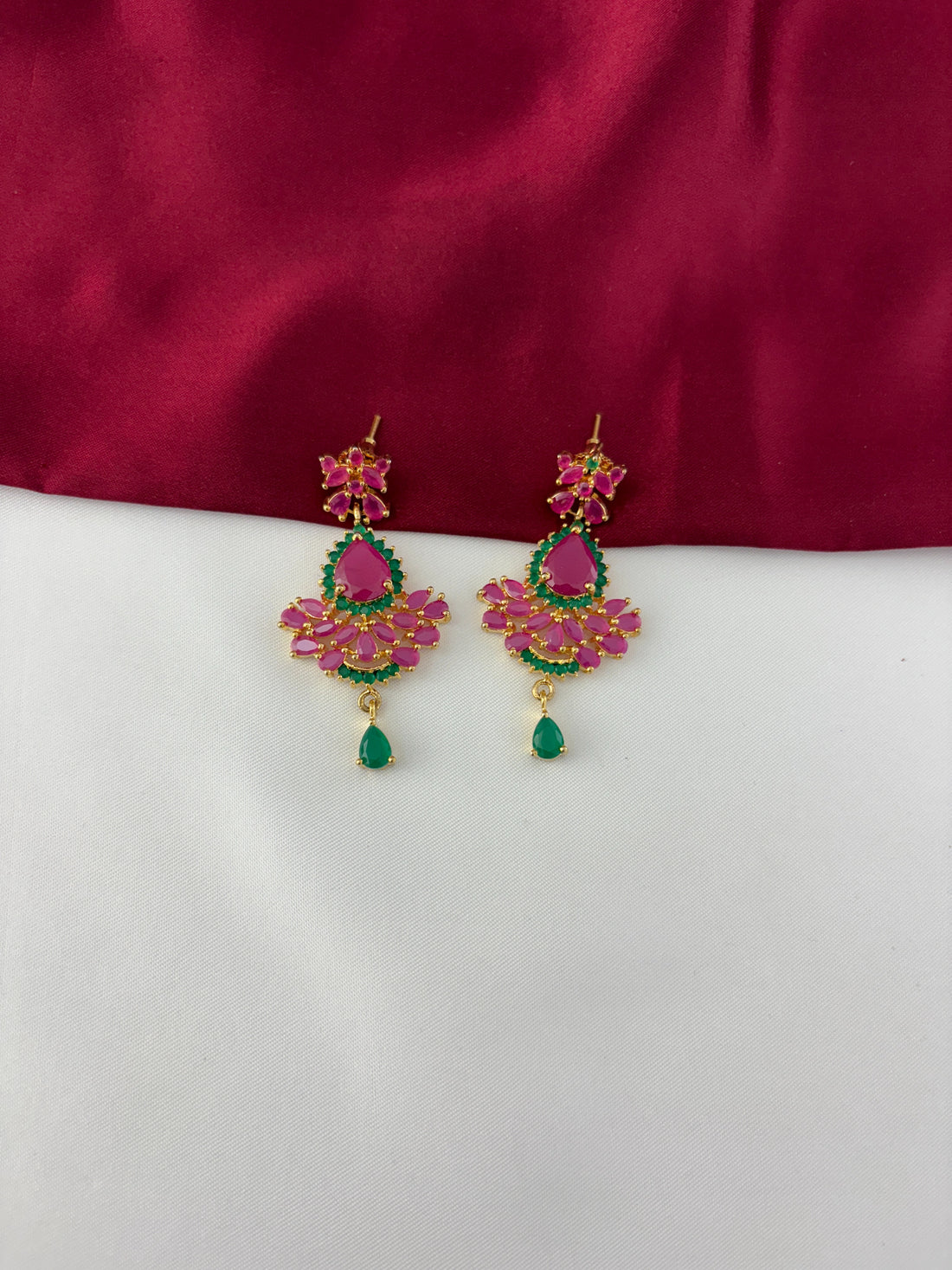FeelOri Gold Plated Ruby Emerald Earrings - Detailed view highlighting the vibrant ruby and emerald stone arrangement with a delicate green drop.