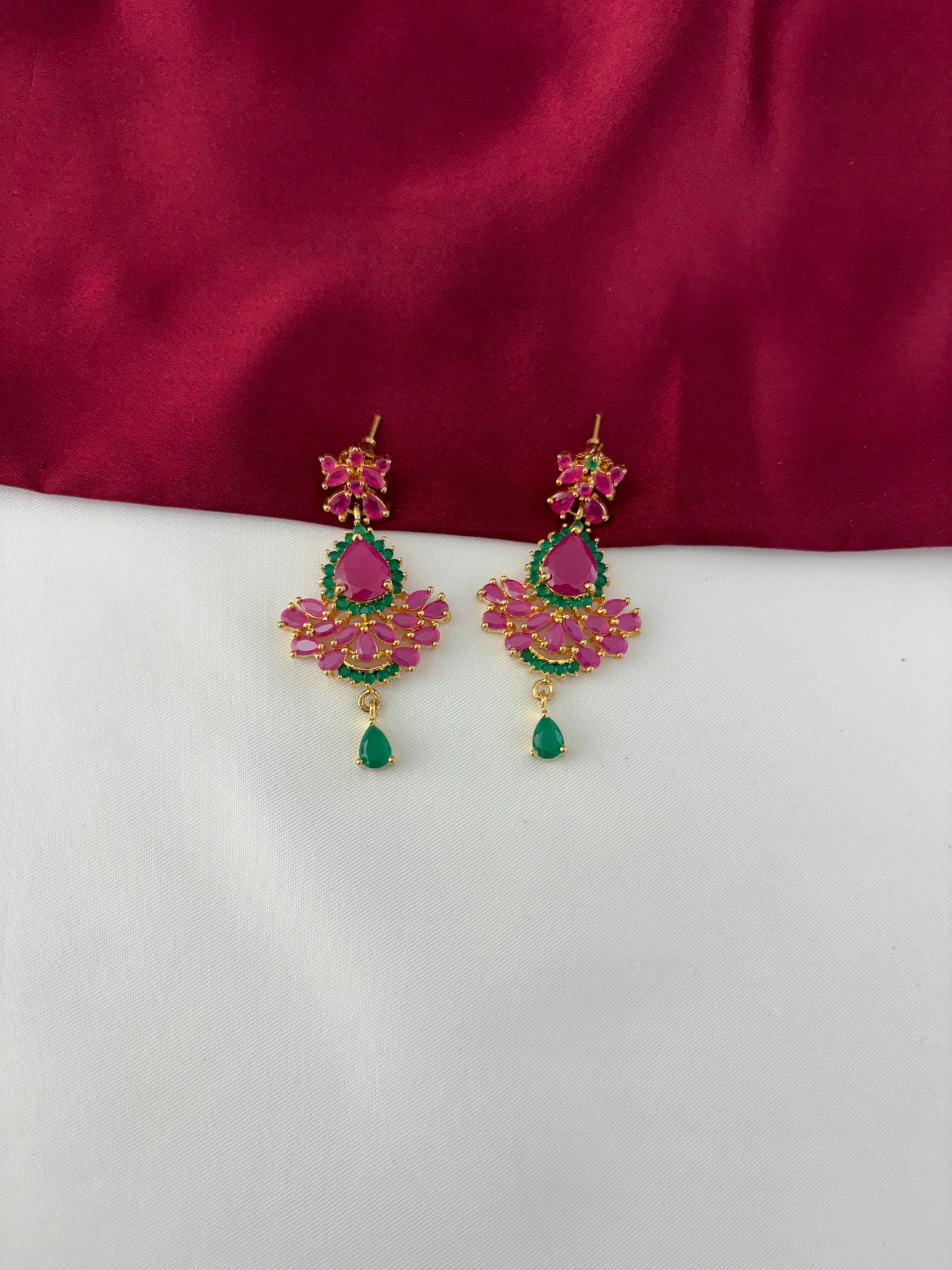FeelOri Gold Plated Ruby Emerald Earrings - Detailed view highlighting the vibrant ruby and emerald stone arrangement with a delicate green drop.