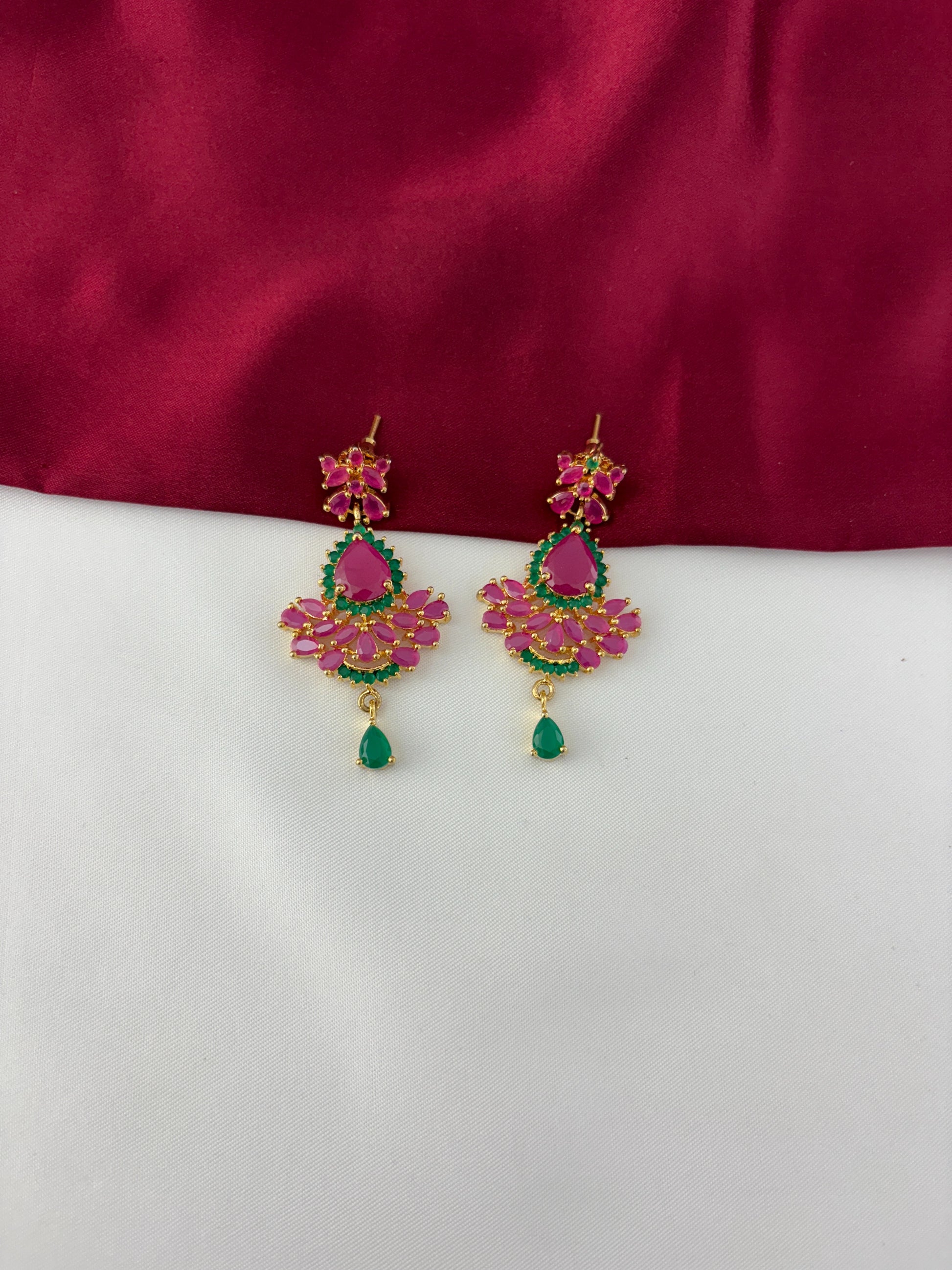 FeelOri Gold Plated Ruby Emerald Earrings - Detailed view highlighting the vibrant ruby and emerald stone arrangement with a delicate green drop.