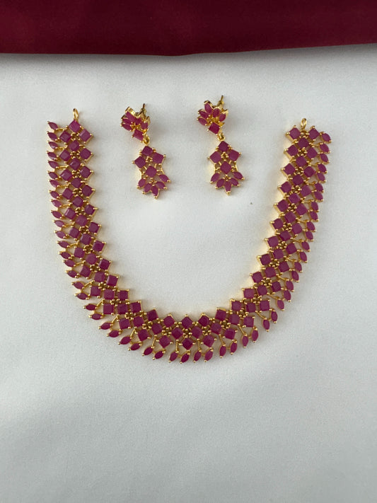 FeelOri Gold Plated Ruby Petal Cluster Necklace and Earrings Set - Flatlay view showcasing the full set's vibrant design.