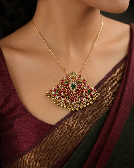 Model wearing the FeelOri broad twin-peacock Jadau Kundan pendant with a maroon silk saree
