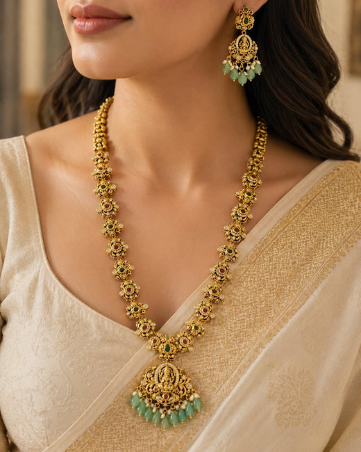 FeelOri Emerald Lakshmi Pendant Necklace Set for Pattu Sarees with matching earrings, jewellery display view
