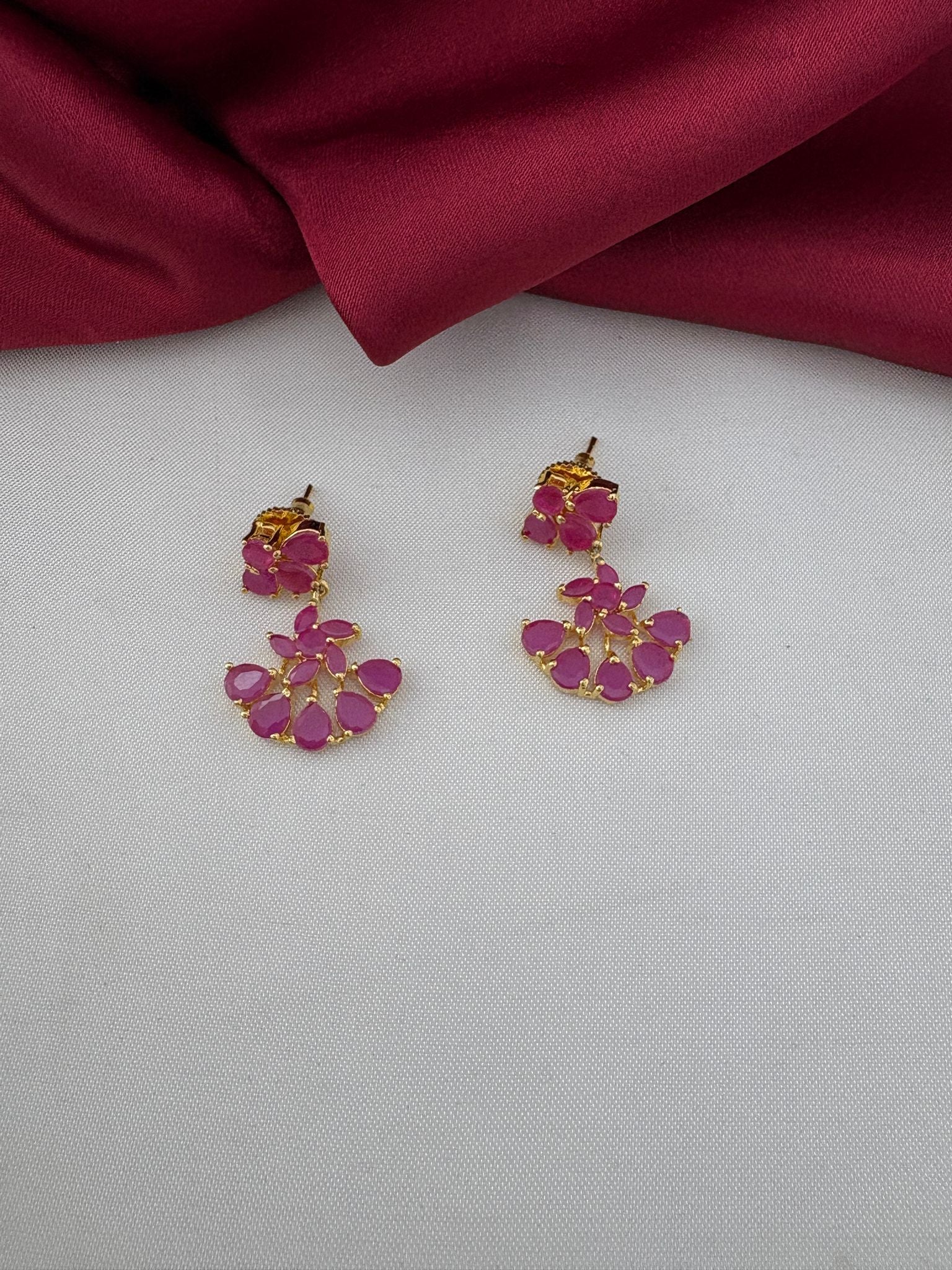 Close-up of FeelOri Antique Finish Ruby-Tone CZ earrings, part of the short necklace set. Detailed view of the ruby floral design on the earrings.