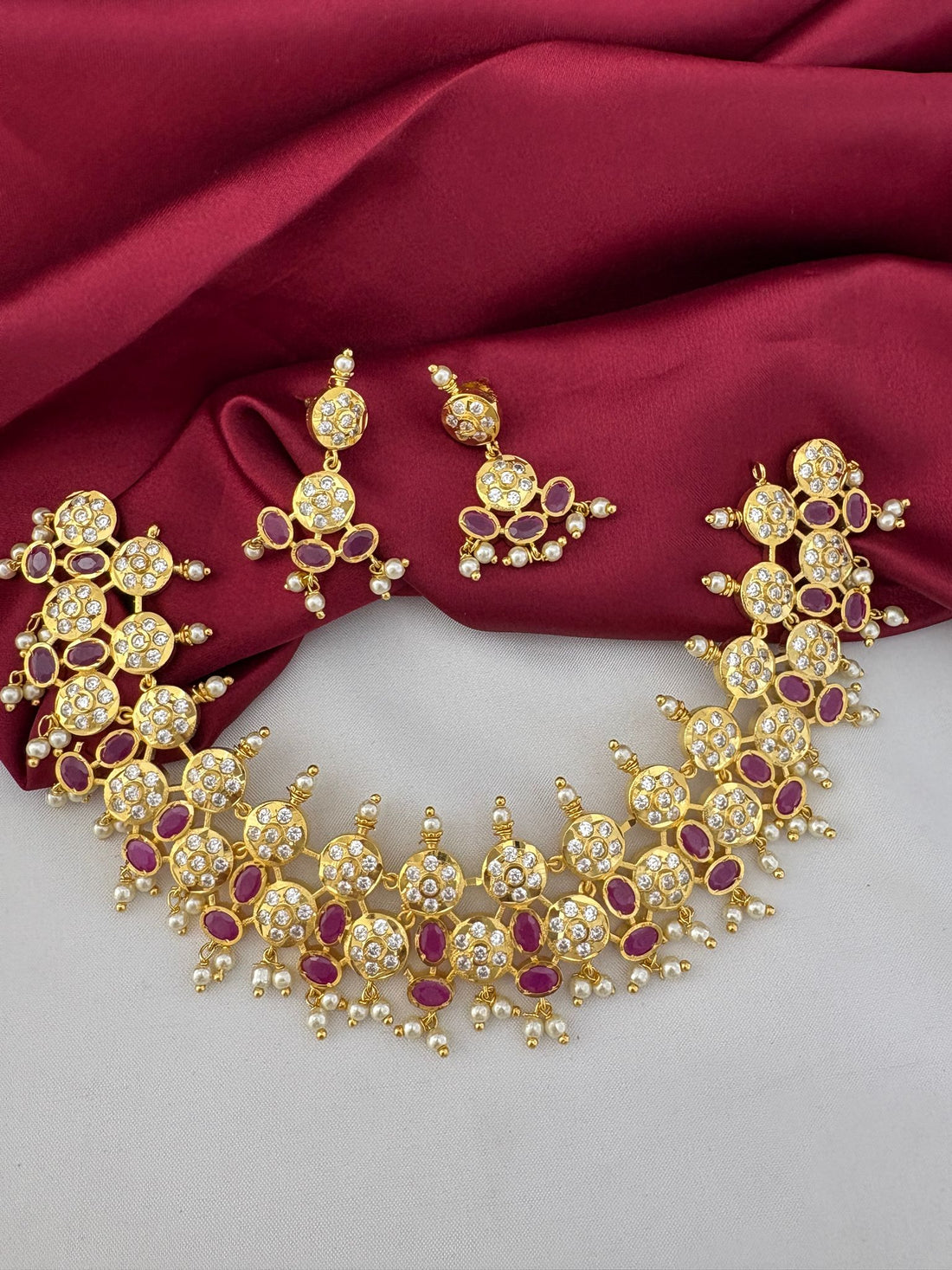 FeelOri Aurora Ruby & AD Halo Bridal Set - front view of gold necklace and earrings with red and clear stones, perfect for Hyderabad weddings.