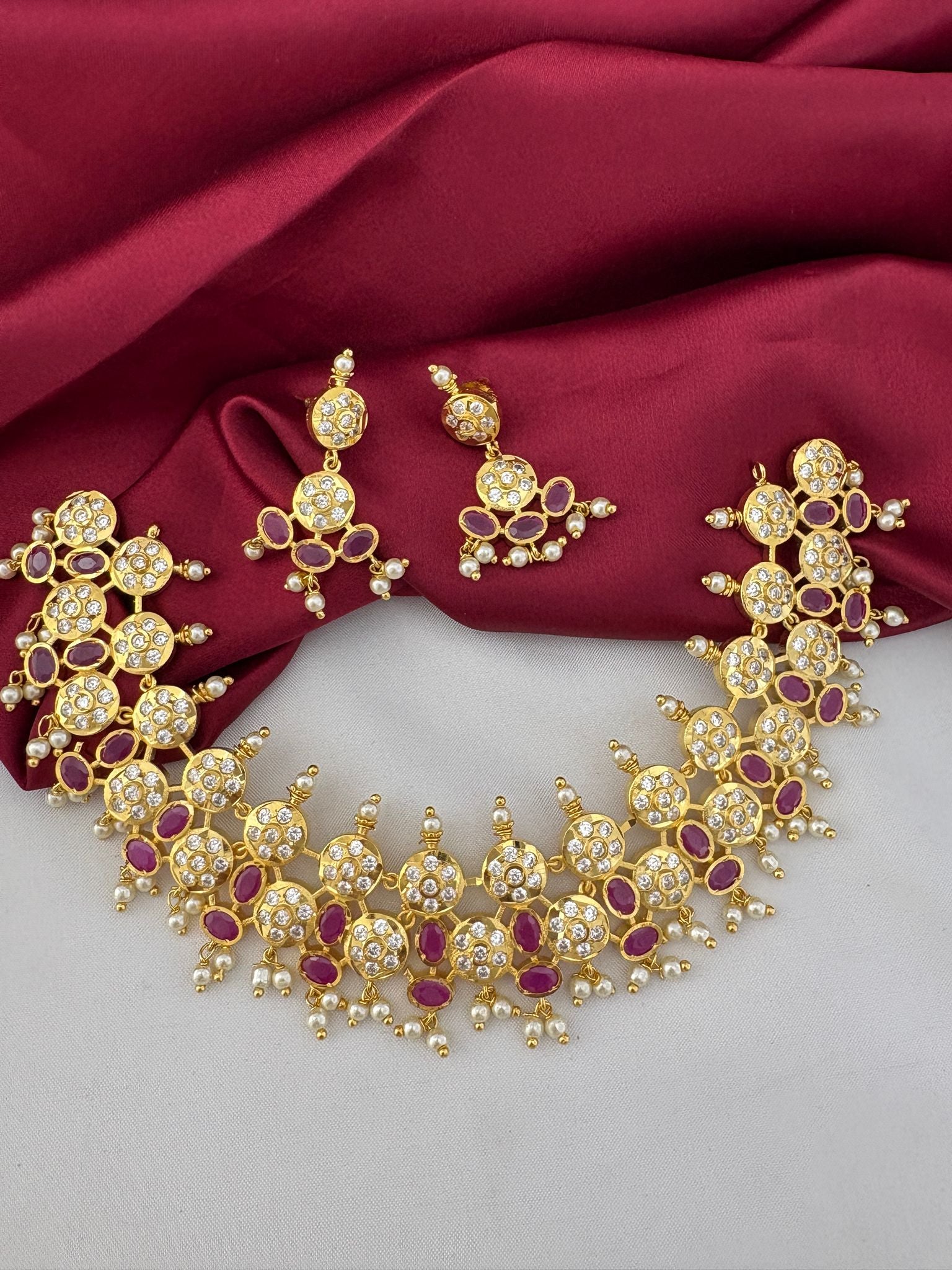 FeelOri Aurora Ruby & AD Halo Bridal Set - front view of gold necklace and earrings with red and clear stones, perfect for Hyderabad weddings.