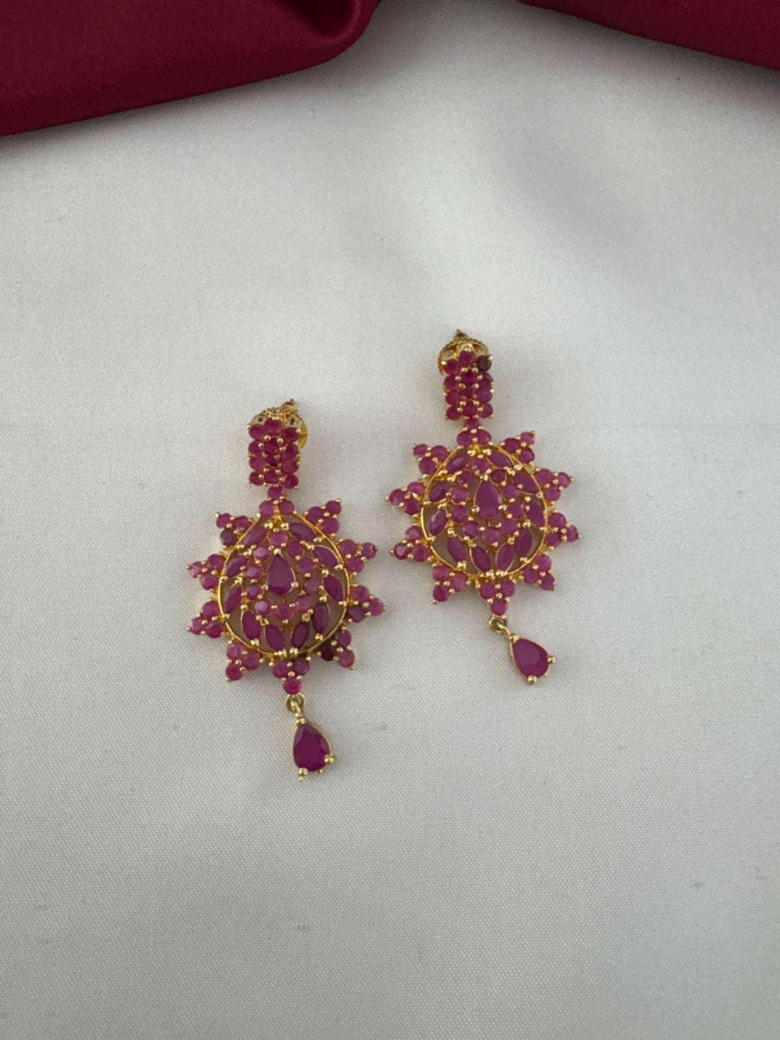 Close-up of FeelOri Bold Statement Ruby-Tone CZ Earrings showcasing intricate stone details and design.