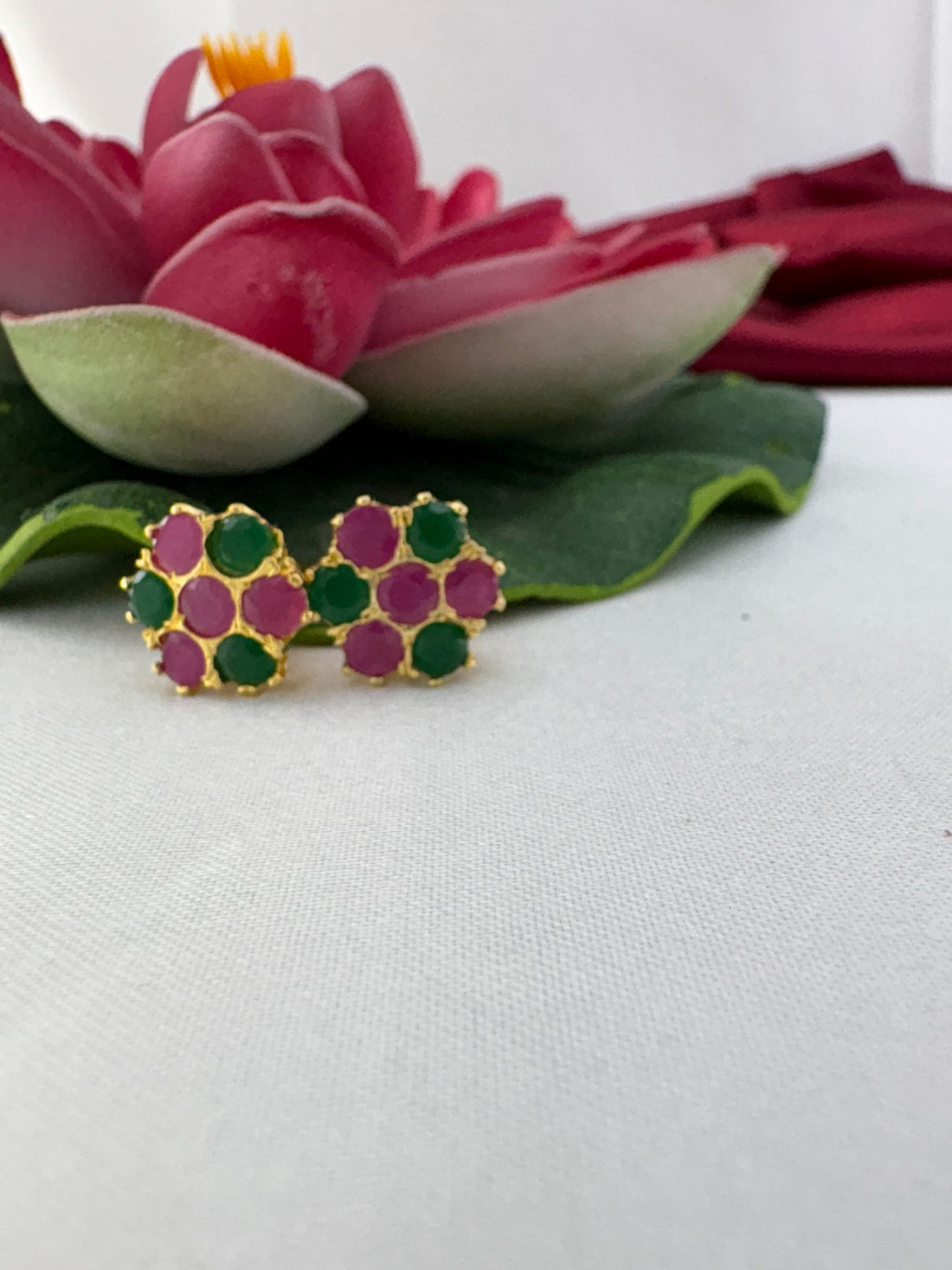 FeelOri cherry blossom pink forest green AD studs styled with lotus showcasing Japanese spring garden serenity
