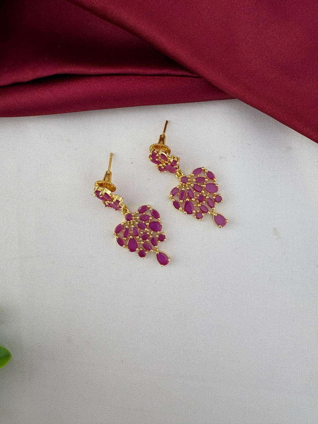 Detailed close-up of ruby earrings from the FeelOri Classic Ruby-Tone CZ Necklace Set by feelori.