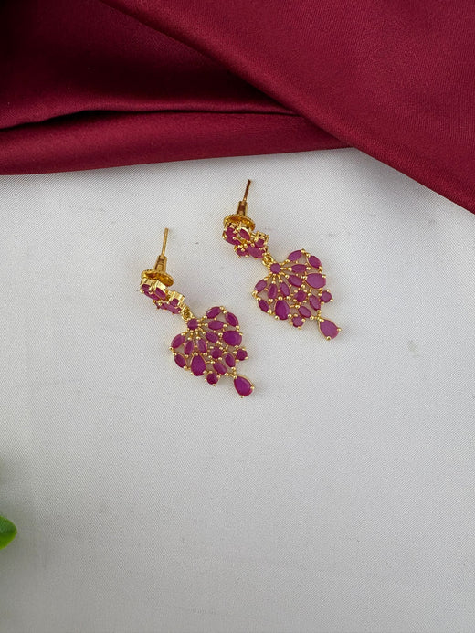Detailed close-up of ruby earrings from the FeelOri Classic Ruby-Tone CZ Necklace Set by feelori.