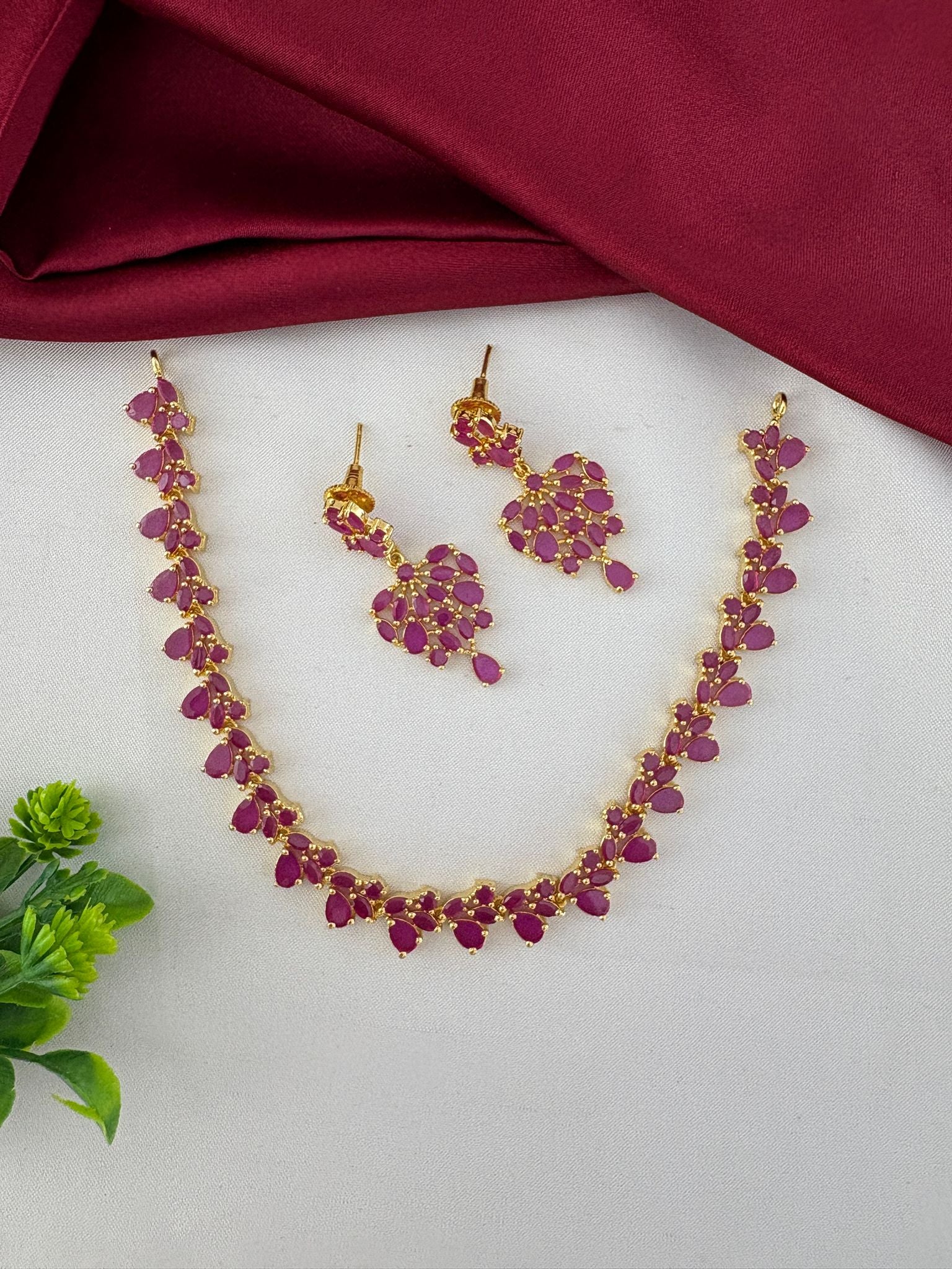 Styled view of the FeelOri Classic Ruby-Tone CZ Short Necklace Set. Elegant design by feelori.