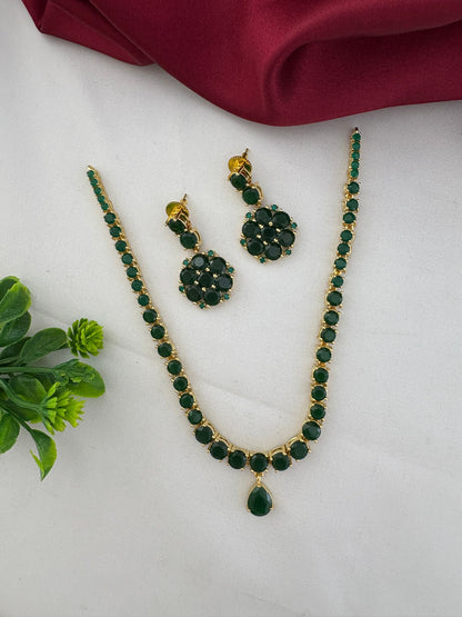 FeelOri Deccan Spring Emerald Short Necklace Set styled with elegant fabric and a touch of greenery, showcasing the complete set.