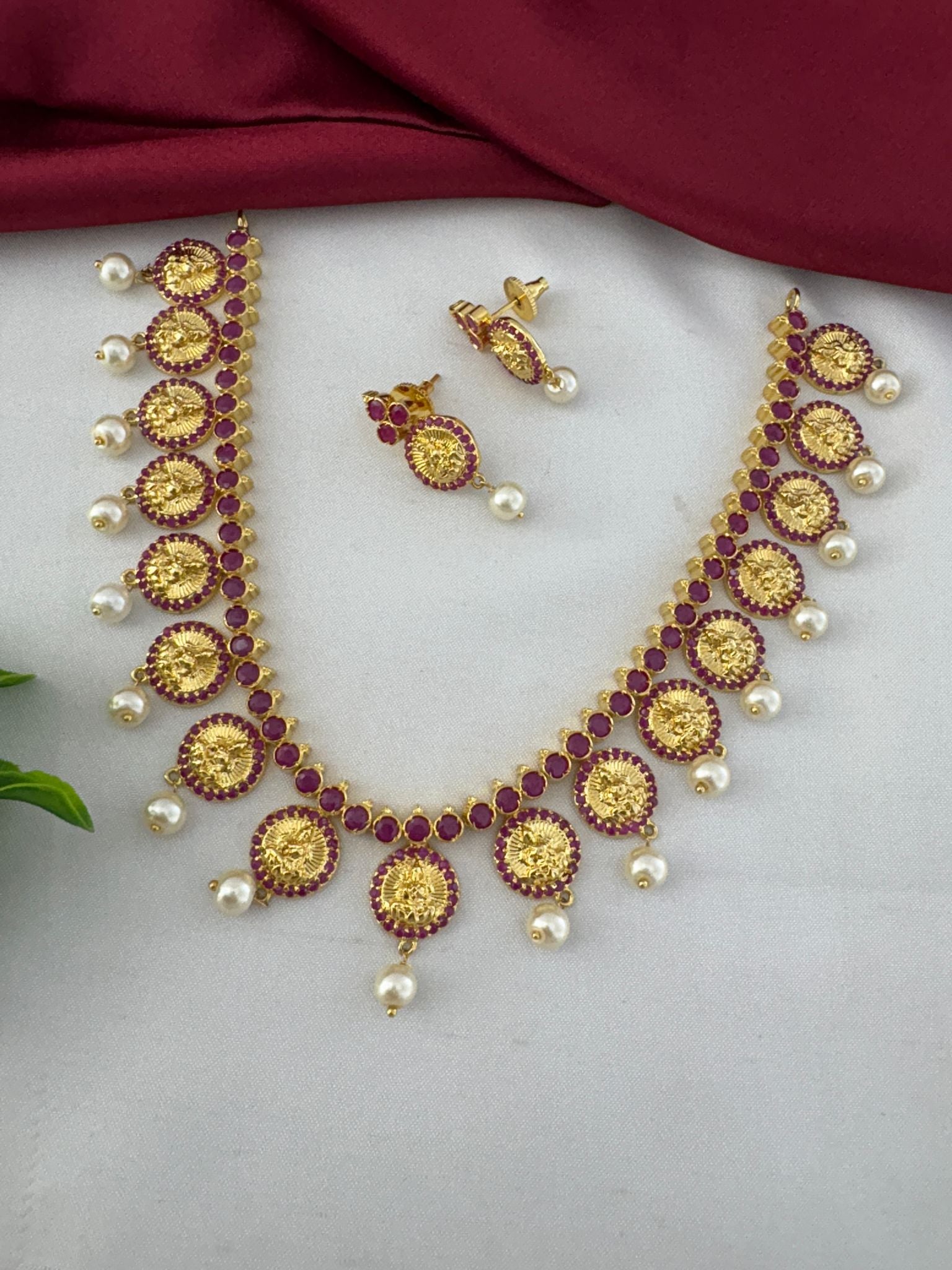 FeelOri Designer Ruby-Tone CZ Short Necklace Set with Modern Twist - Angled overview of the gold-tone necklace and earrings.