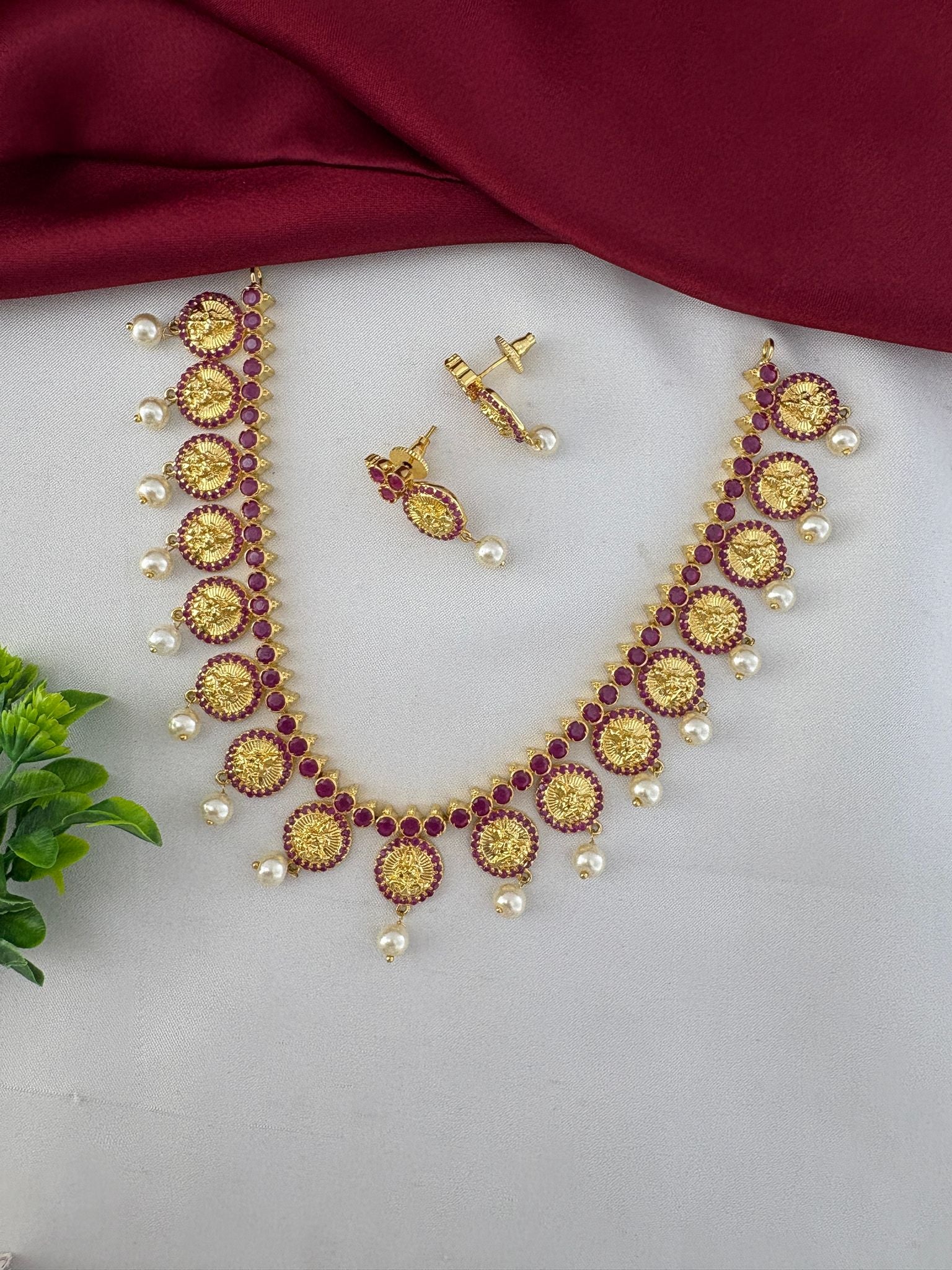 FeelOri Designer Ruby-Tone CZ Short Necklace Set with Modern Twist - Necklace and earrings styled with a decorative green accent.