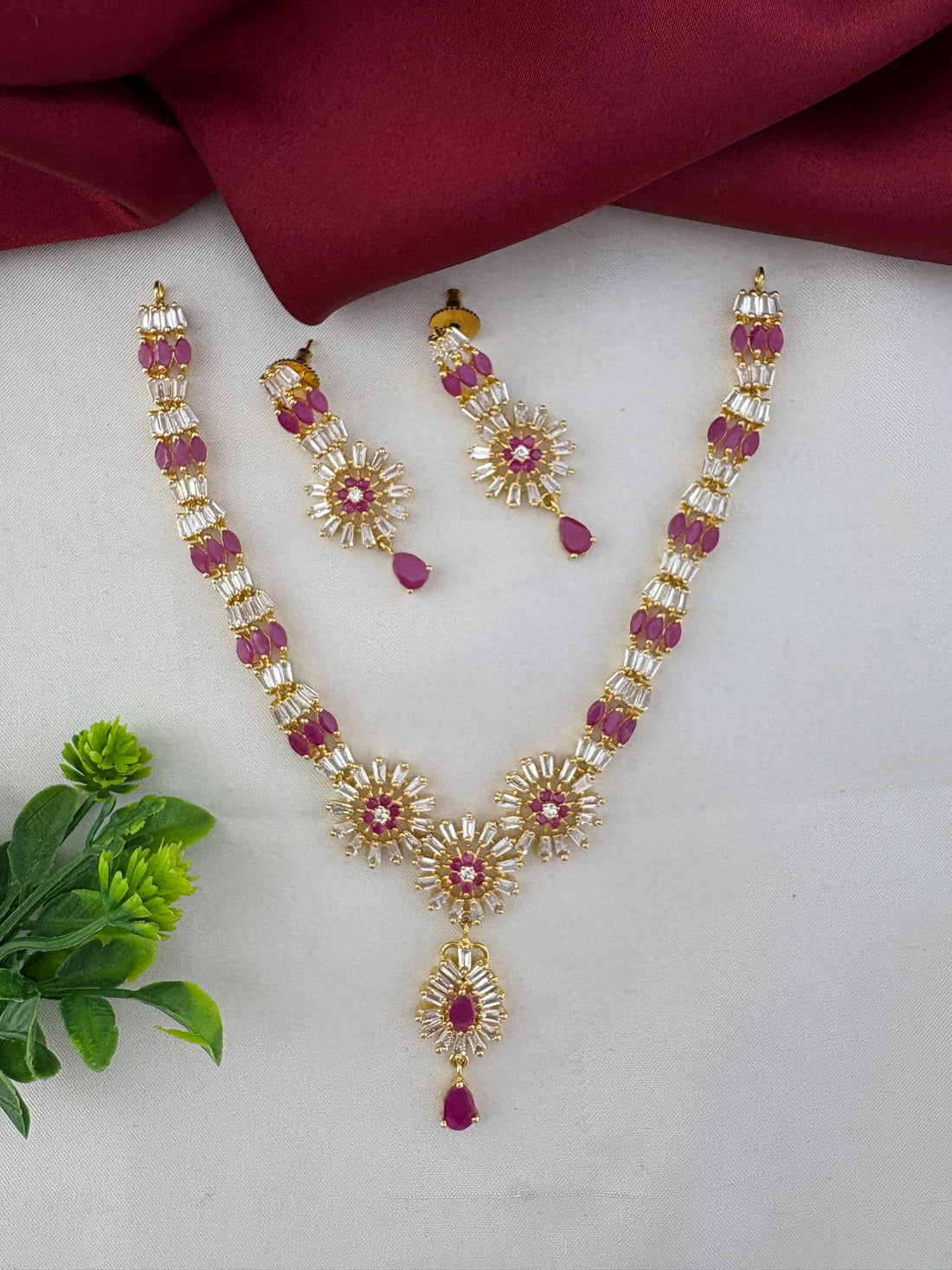 FeelOri Divine Ruby-Tone CZ Short Necklace Set - Temple Collection, featuring intricate floral design with ruby and clear stones. Includes matching earrings.