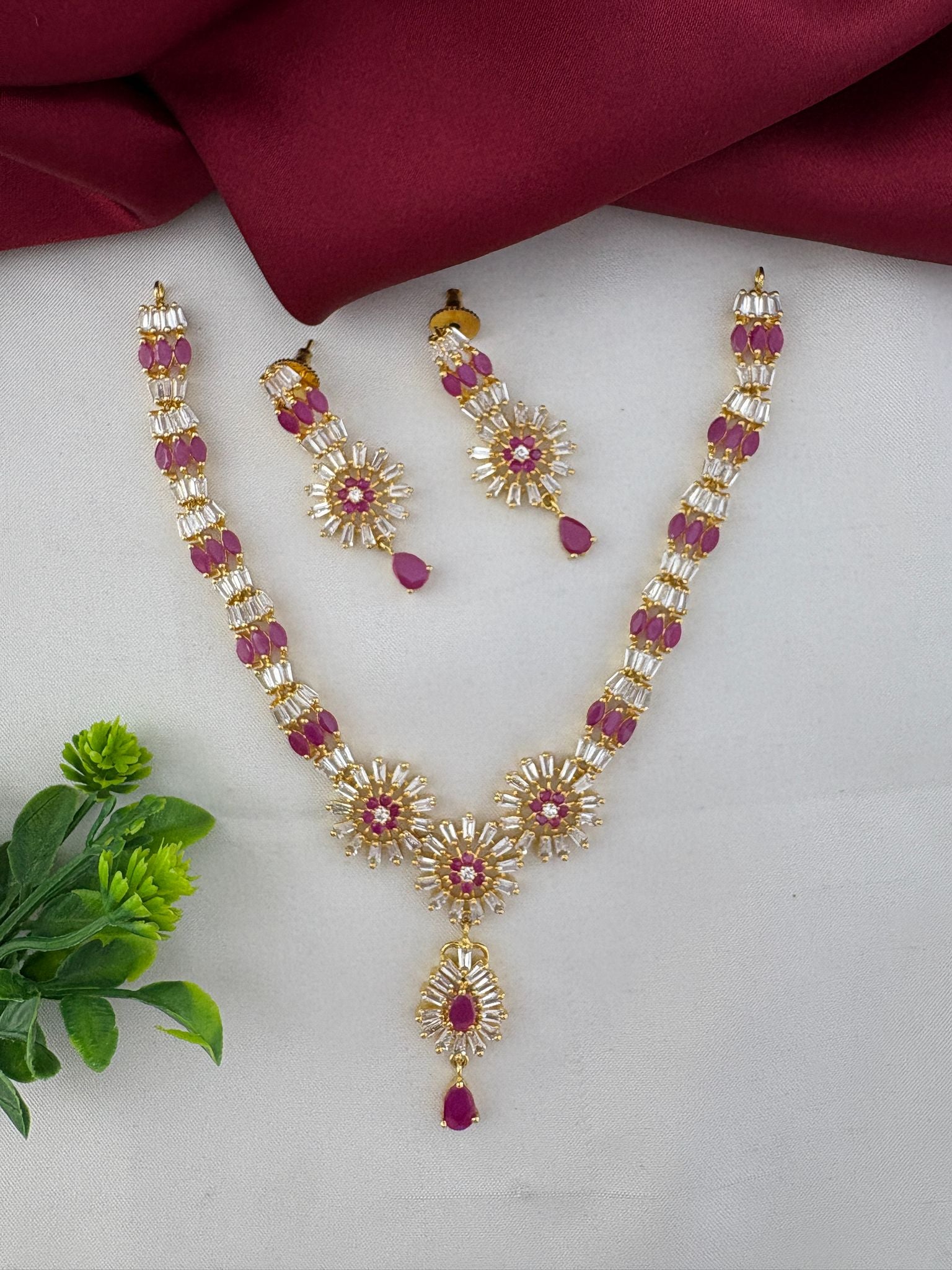 FeelOri Divine Ruby-Tone CZ Short Necklace Set - Temple Collection, featuring intricate floral design with ruby and clear stones. Includes matching earrings.