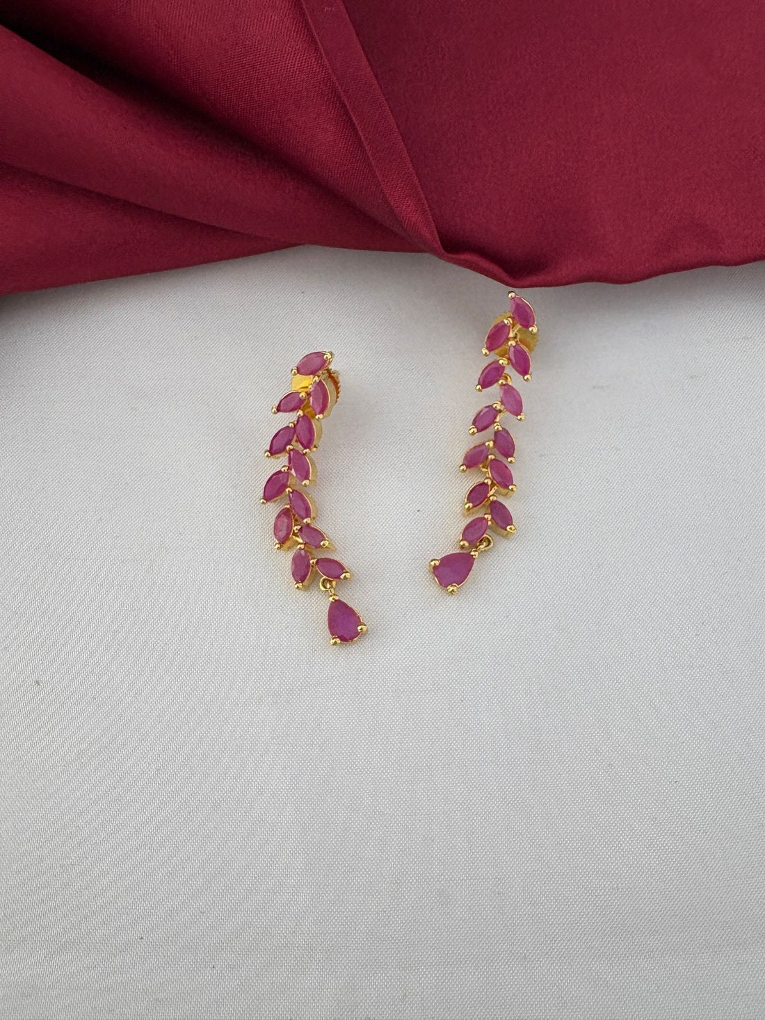 Detailed close-up of FeelOri's Elegant Ruby-Tone CZ Earrings, part of the short necklace set for Bangalore events, showcasing the marquise-cut ruby stones.