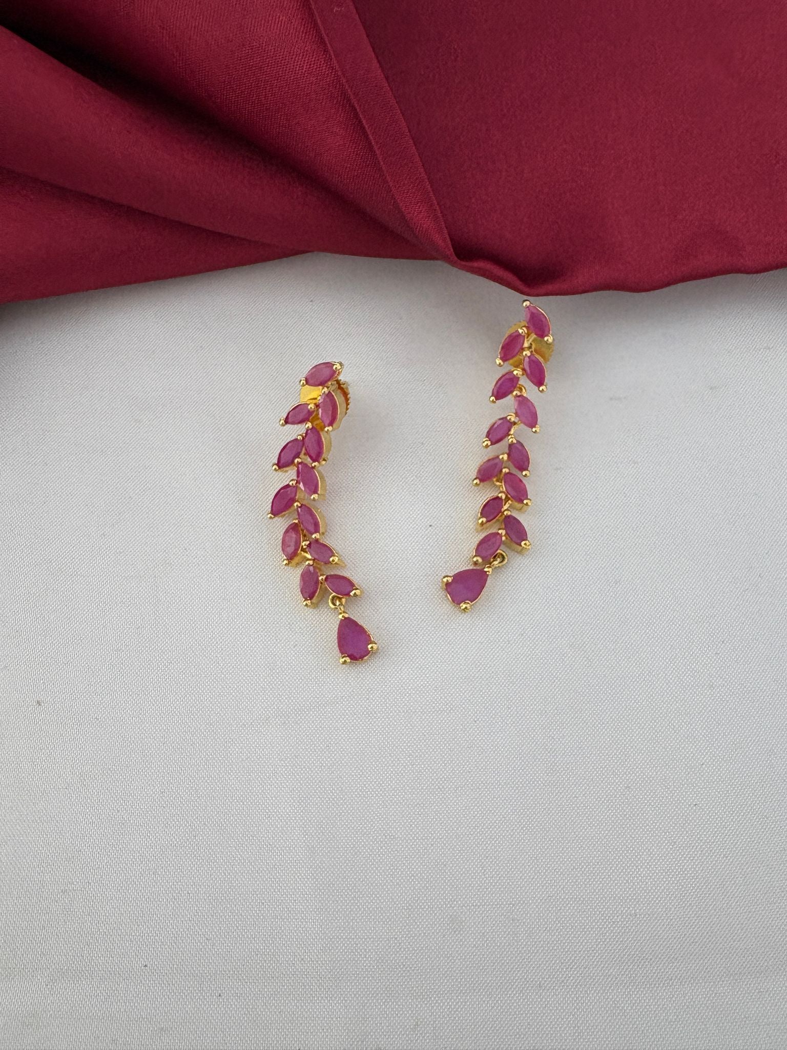 Detailed close-up of FeelOri's Elegant Ruby-Tone CZ Earrings, part of the short necklace set for Bangalore events, showcasing the marquise-cut ruby stones.