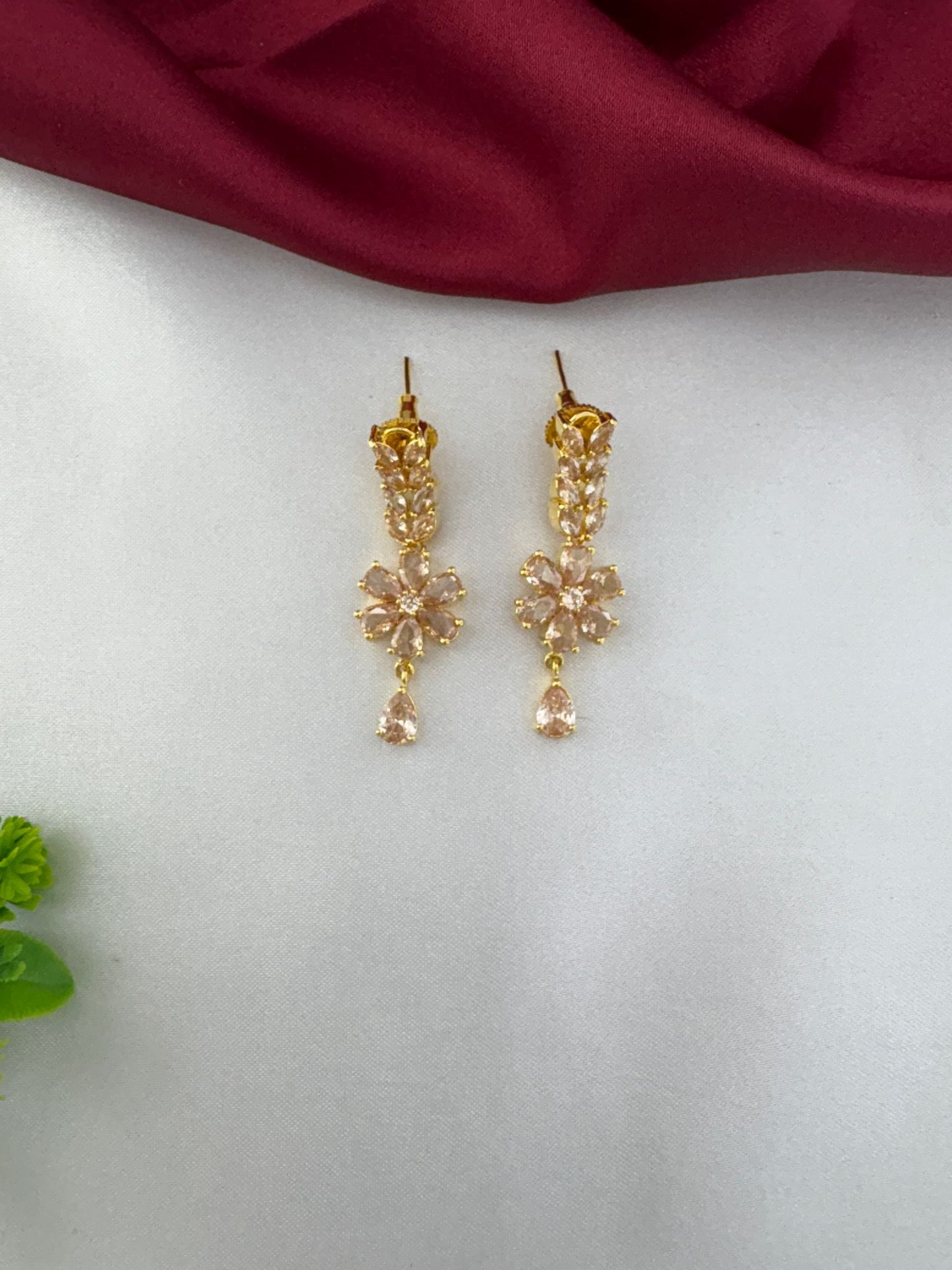 Close-up of FeelOri Festive Sunbeam Gold AD Stone floral drop earrings.