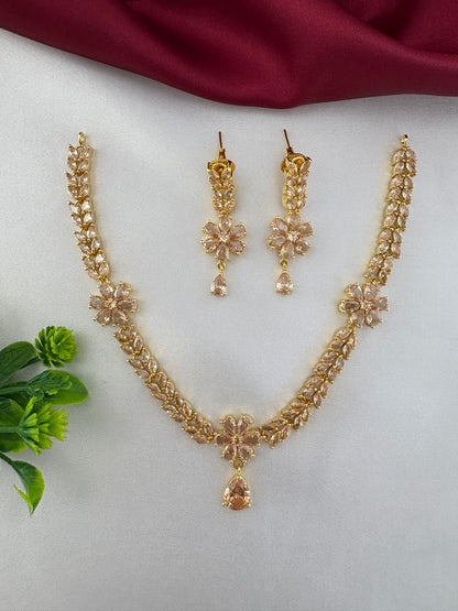 Angled view of FeelOri Festive Sunbeam Gold AD Stone Short Set showcasing necklace pendant and earring details.
