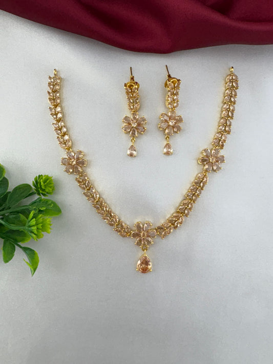 FeelOri Festive Sunbeam Gold AD Stone Short Set with floral necklace and matching earrings, top view.
