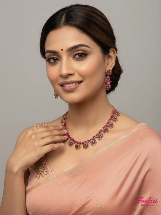 FeelOri Gold Plated Floral Ruby Emerald Necklace Set - Model wearing traditional peach saree, smiling gracefully.
