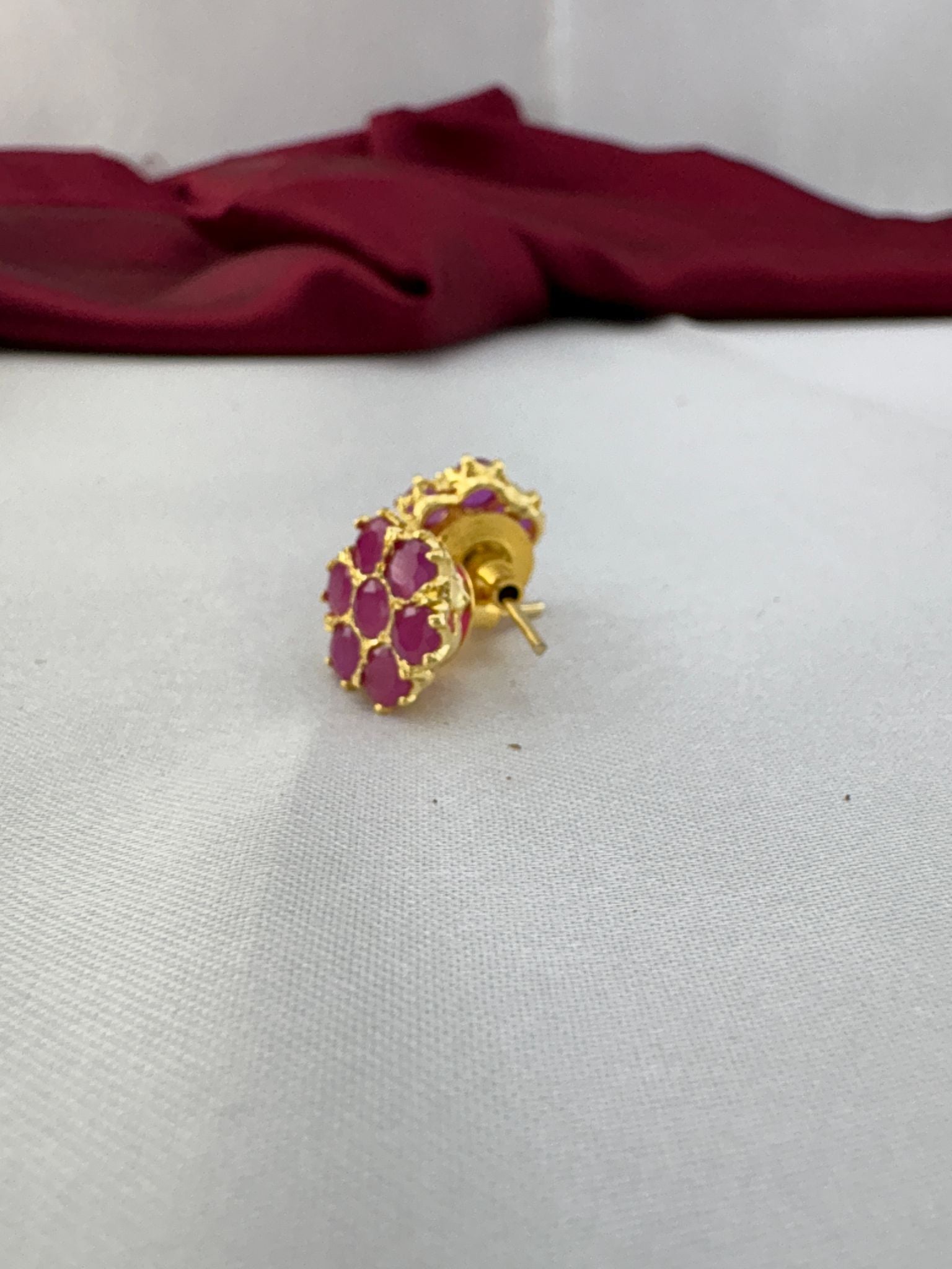 FeelOri Fuchsia Flash bright pink AD stud earrings angled view displaying gold post mechanism and secure back