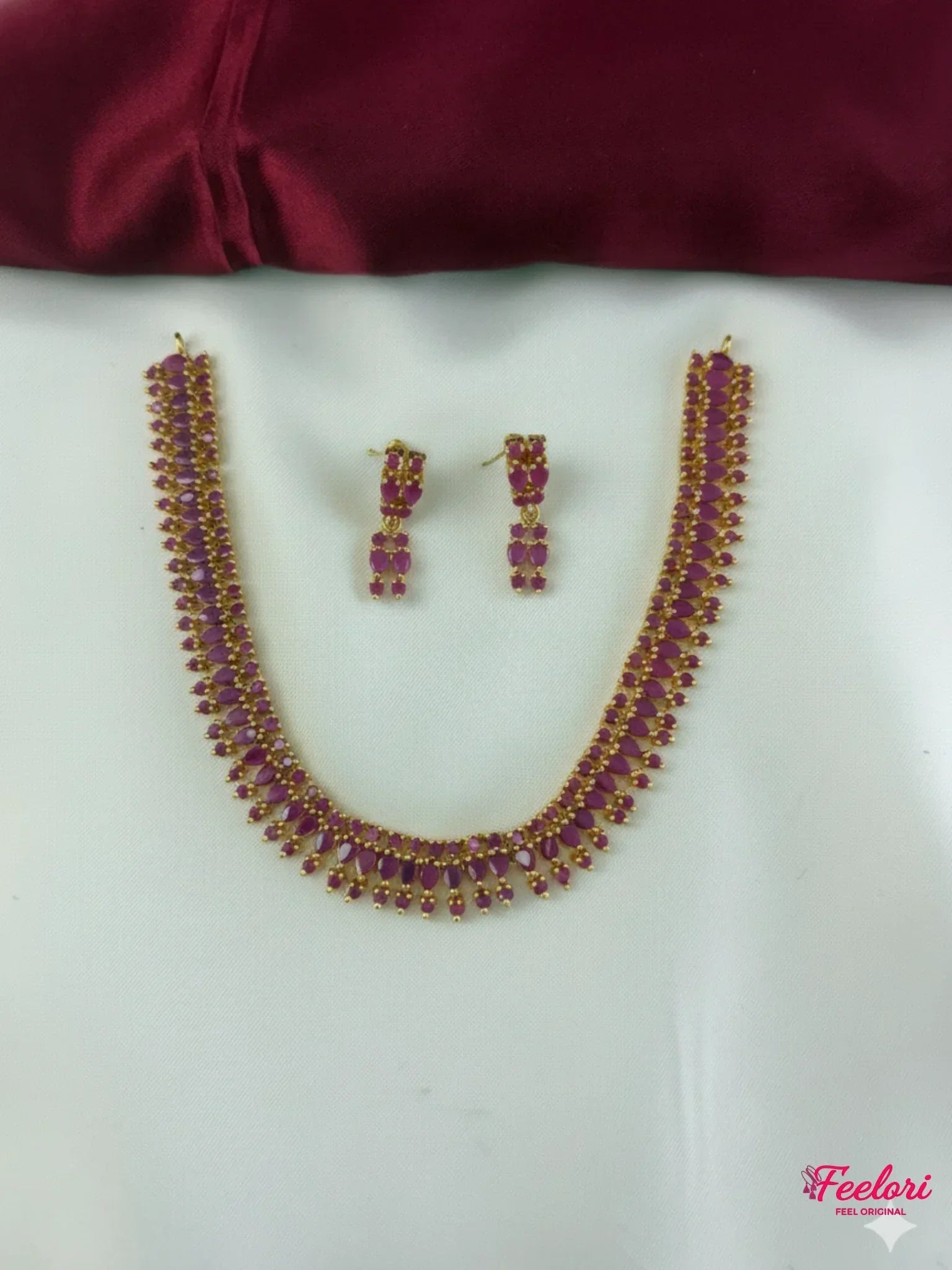 FeelOri Gold Plated Ruby Drop Necklace Set - Front view showcasing the full necklace with its graduating ruby-like stones and matching earrings.