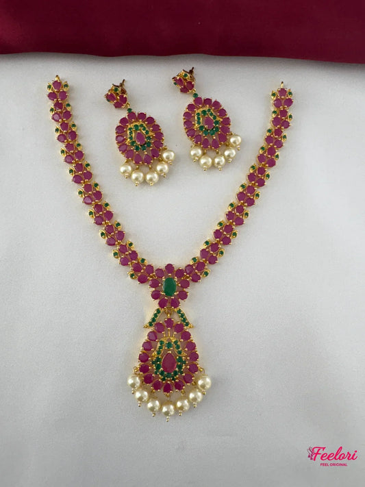 FeelOri Gold Plated Ruby Emerald Floral Necklace Set - Front view showcasing the tear-drop pendant, linked floral chain, and matching earrings.