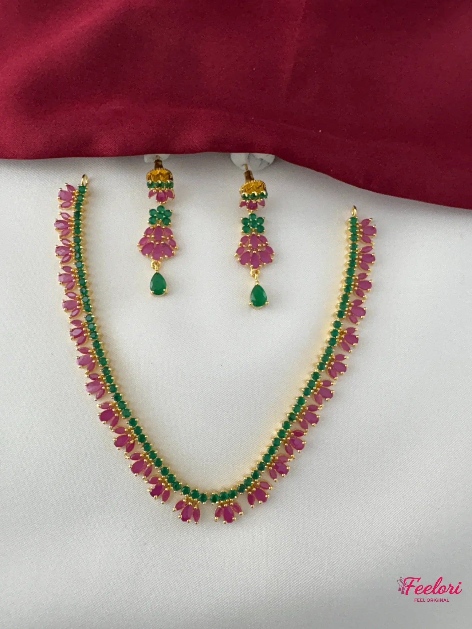 FeelOri Gold Plated Ruby Emerald Floral Petal Garland Necklace Set - Full view showcasing the delicate ruby and emerald petal arrangement on the necklace and matching earrings.