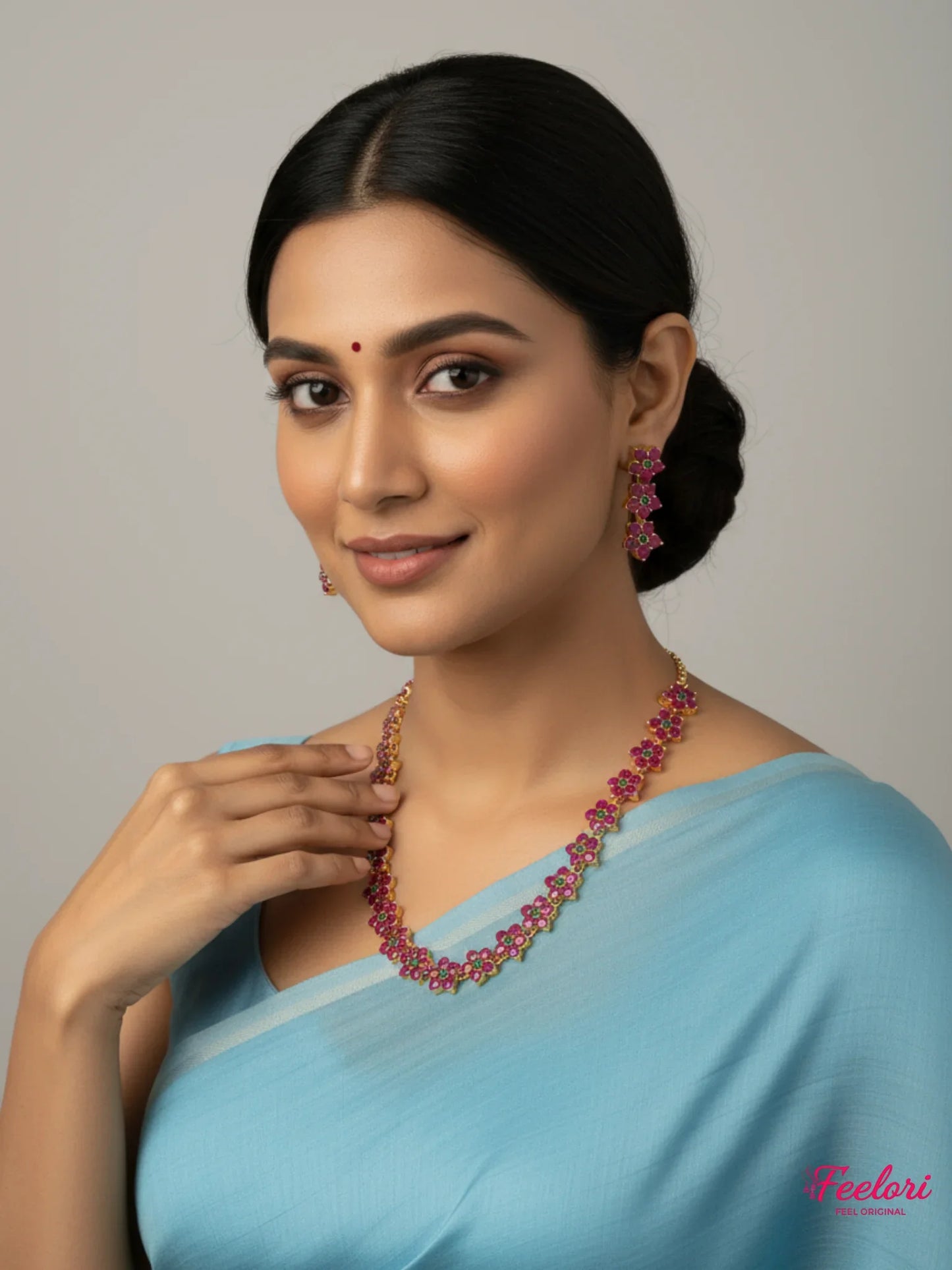 FeelOri Gold Plated Ruby Emerald Flower Chain Necklace Set - Model wearing set with light blue saree.