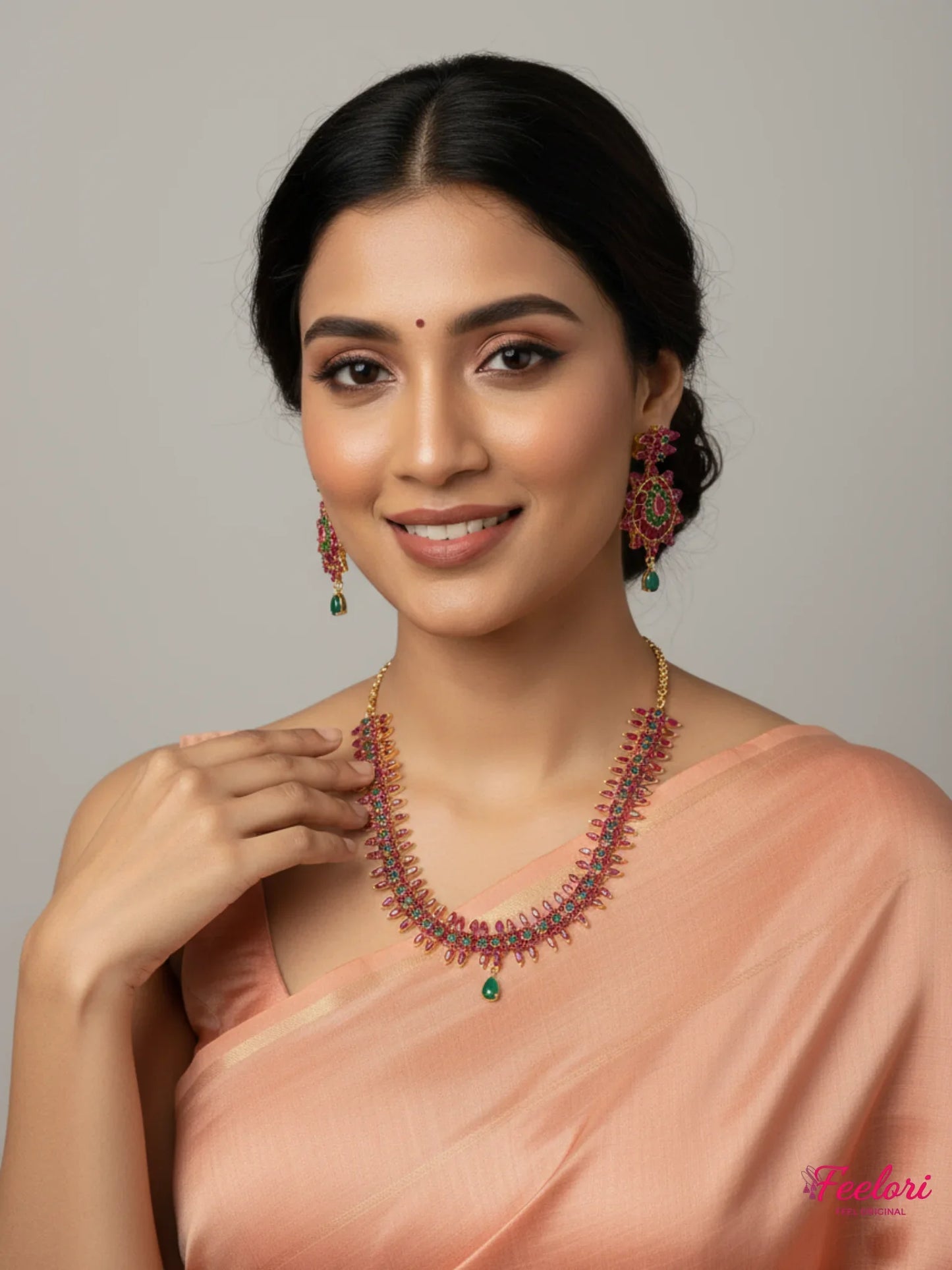 FeelOri Gold Plated Ruby Emerald Flower Petal Necklace Set - Model wearing set with elegant peach saree