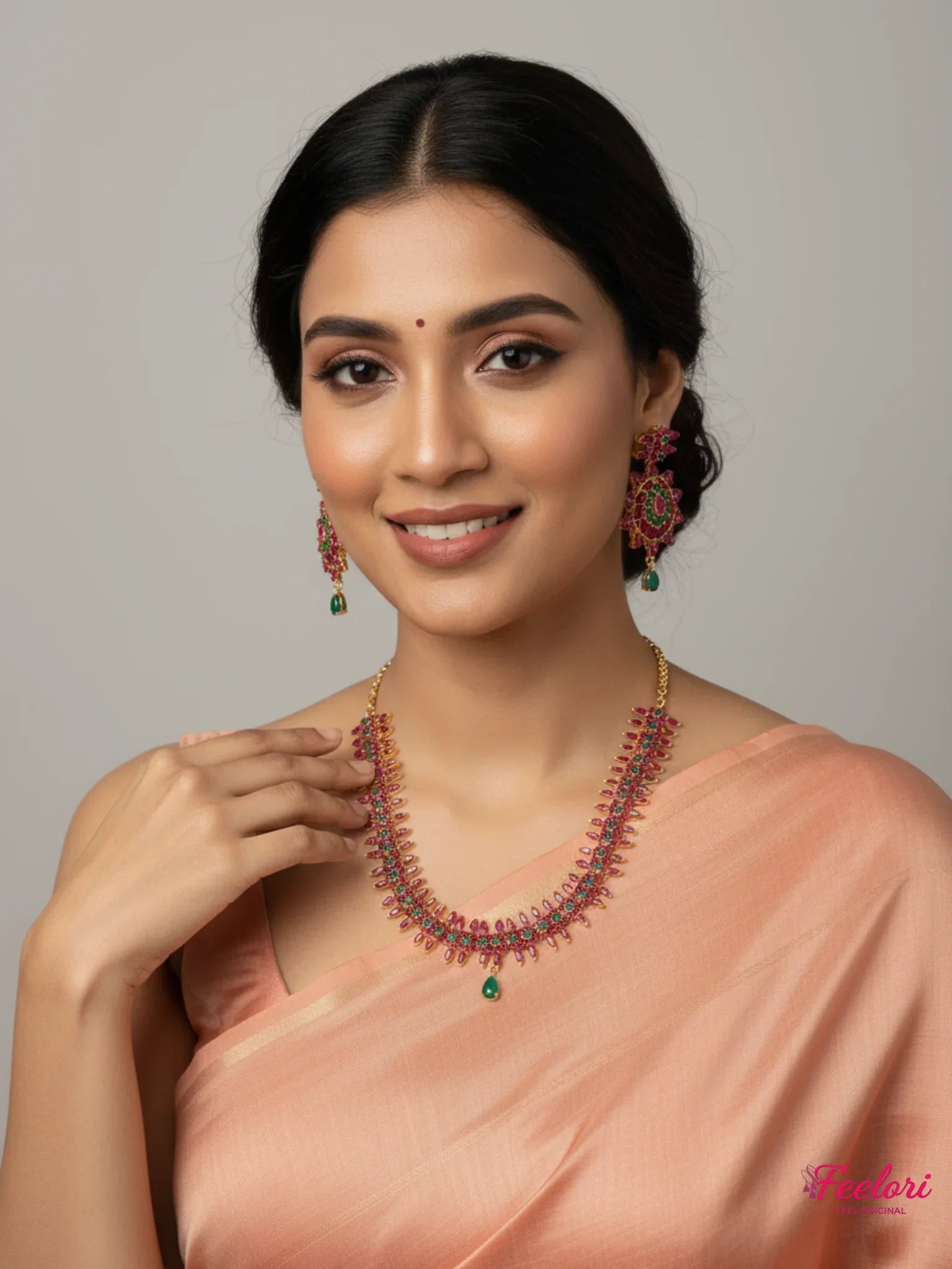 FeelOri Gold Plated Ruby Emerald Flower Petal Necklace Set - Model wearing set with elegant peach saree