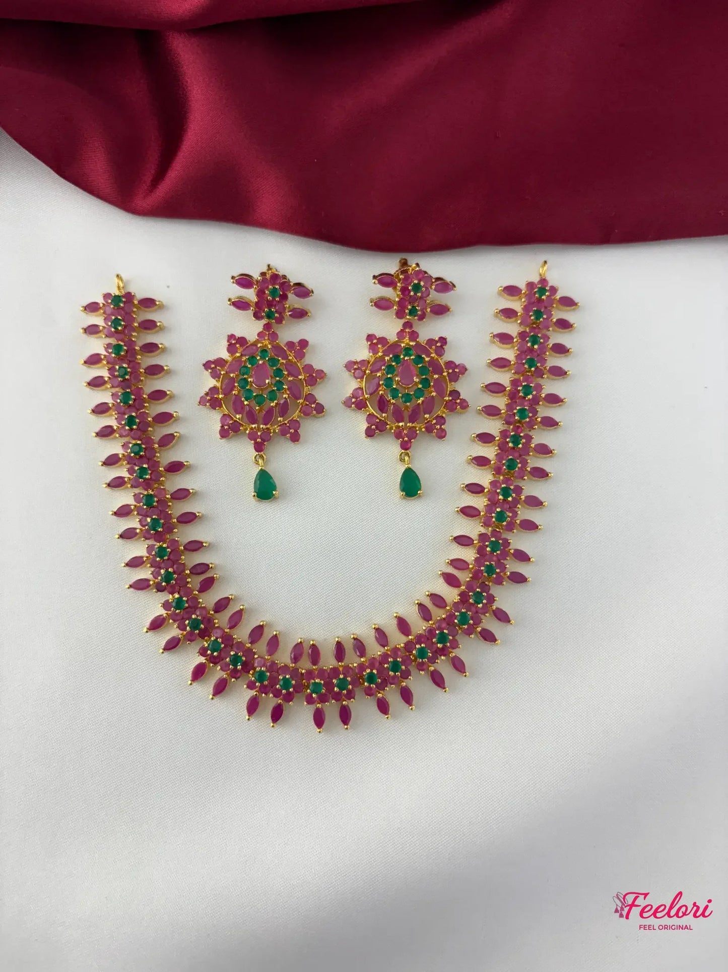 FeelOri Gold Plated Ruby Emerald Flower Petal Necklace Set - Overhead view showcasing the full necklace and matching earrings with delicate stone arrangements.