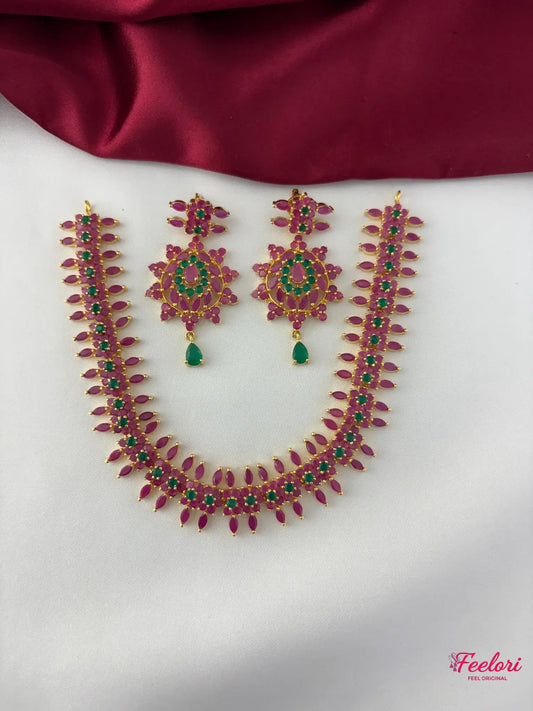 FeelOri Gold Plated Ruby Emerald Flower Petal Necklace Set - Overhead view showcasing the full necklace and matching earrings with delicate stone arrangements.
