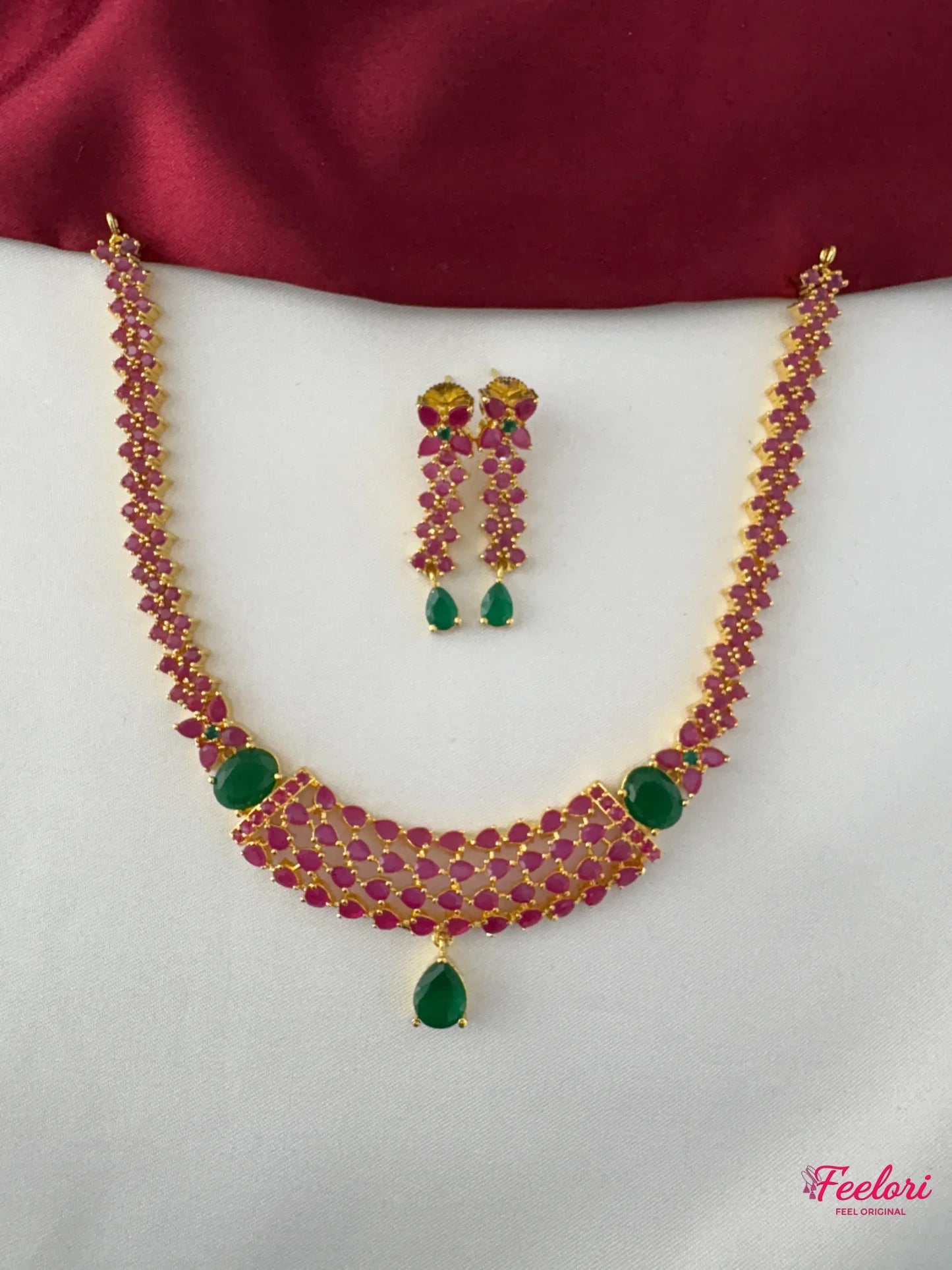 FeelOri Gold Plated Ruby Emerald Layered Necklace Set - Front view showcasing the cascading ruby chains and central emerald drops.