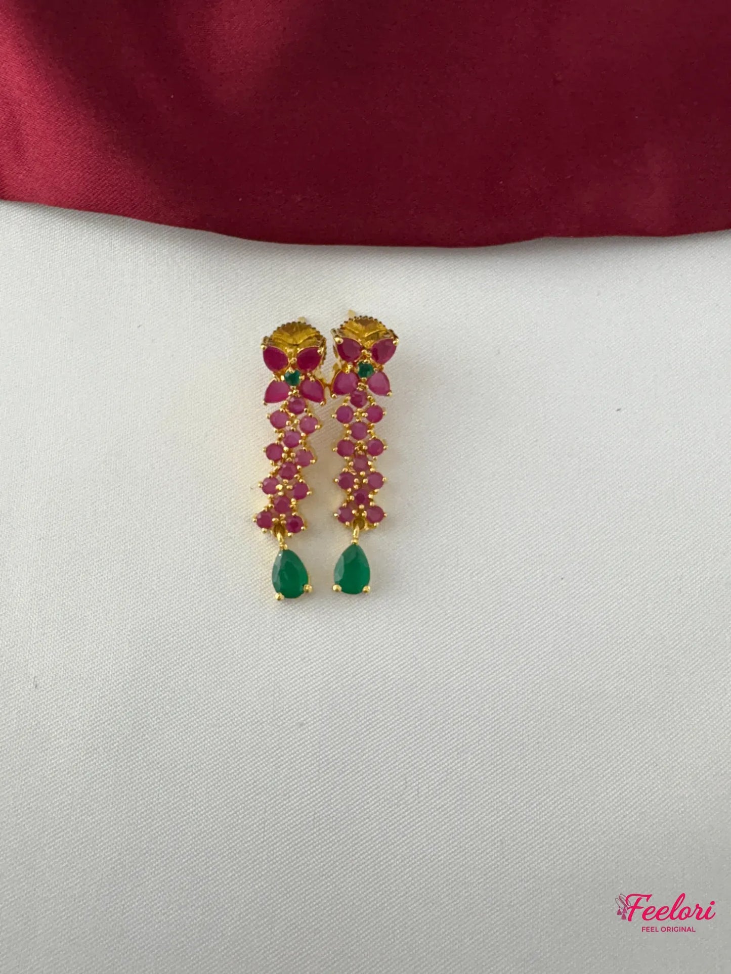 FeelOri Gold Plated Ruby Emerald Drop Earrings - Close-up view revealing detailed ruby clusters and a vibrant emerald teardrop at the base.