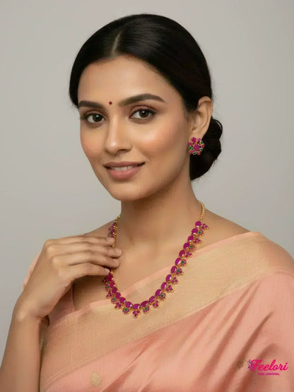 FeelOri Gold Plated Ruby Emerald Layered Petal Necklace Set - Model wearing set with elegant peach saree.