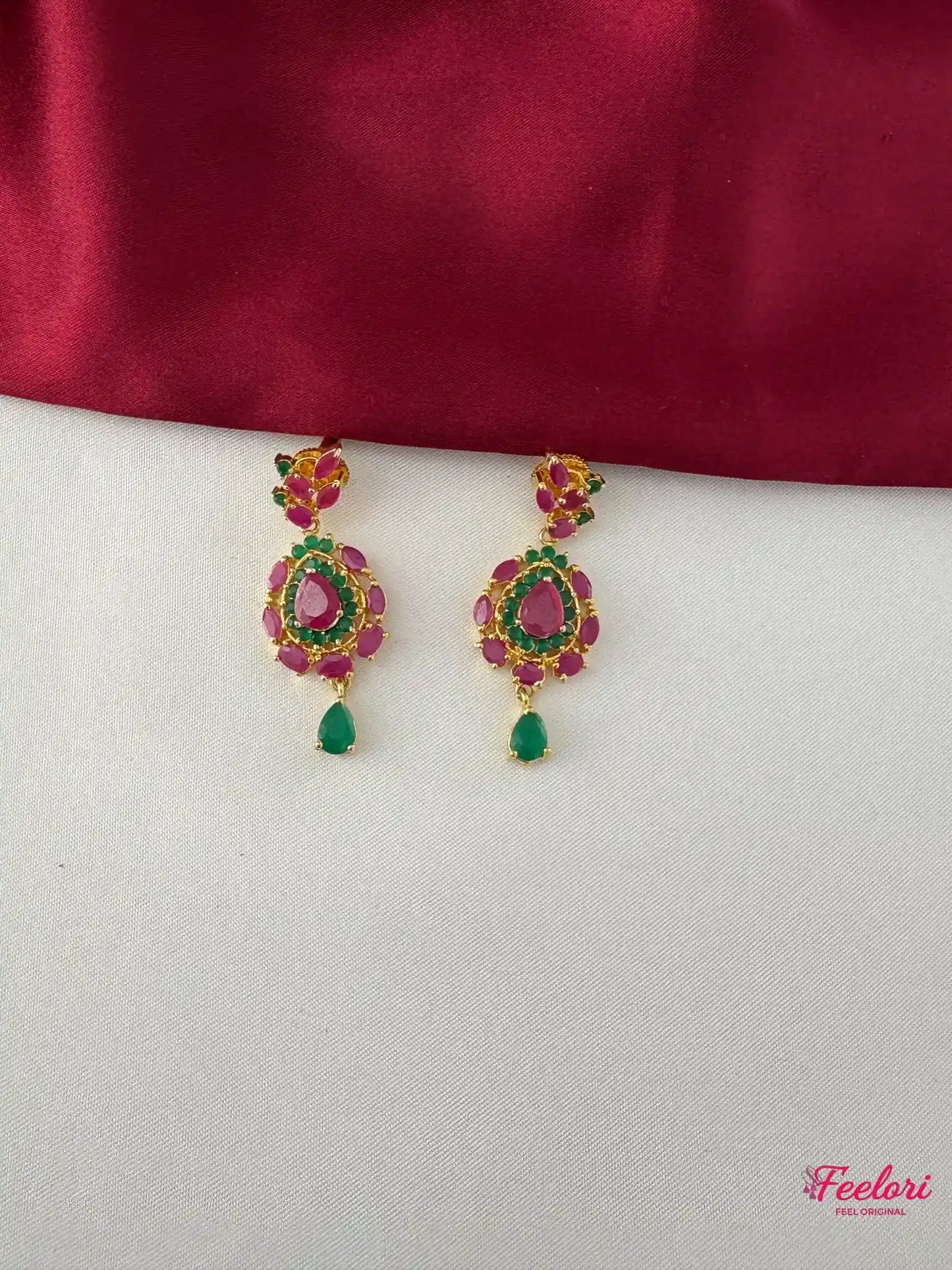 FeelOri Gold Plated Ruby Emerald Drop Earrings - Close-up view highlighting the intricate floral design and teardrop emerald accents.