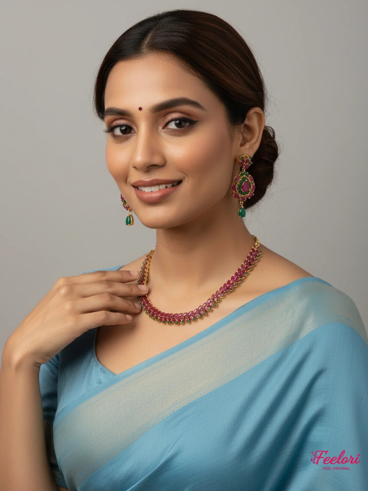 FeelOri Gold Plated Ruby Emerald Leaf Necklace Set - Model in light blue saree, smiling