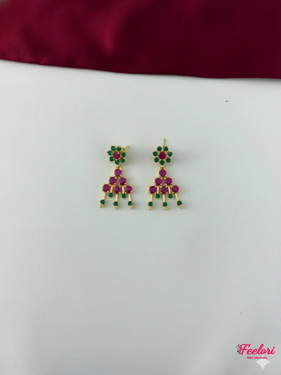FeelOri Gold Plated Ruby Emerald Earrings - Close-up view of the intricate chandelier earrings, highlighting the Ruby-Tone CZ and emerald stone arrangement.