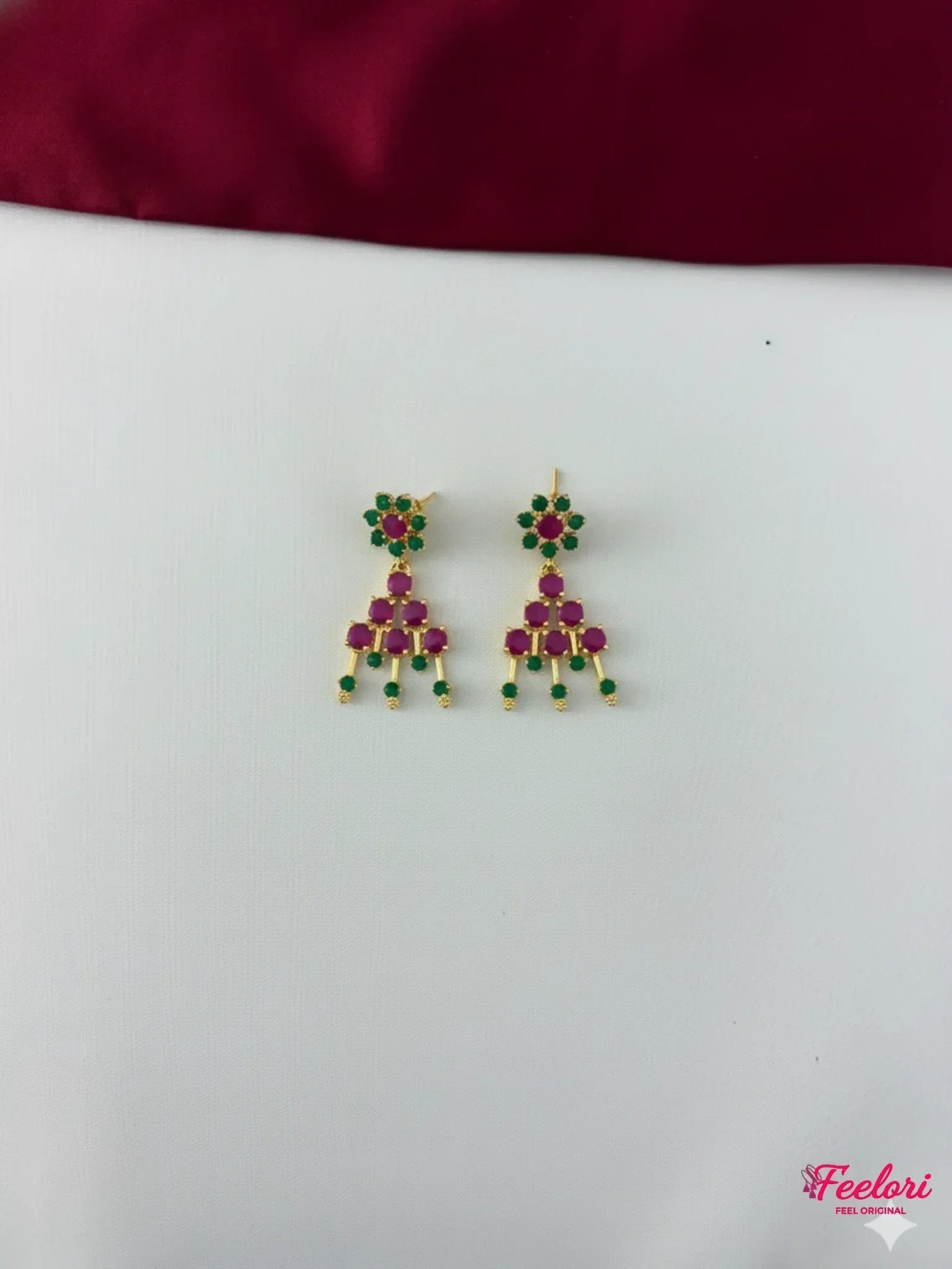 FeelOri Gold Plated Ruby Emerald Earrings - Close-up view of the intricate chandelier earrings, highlighting the Ruby-Tone CZ and emerald stone arrangement.