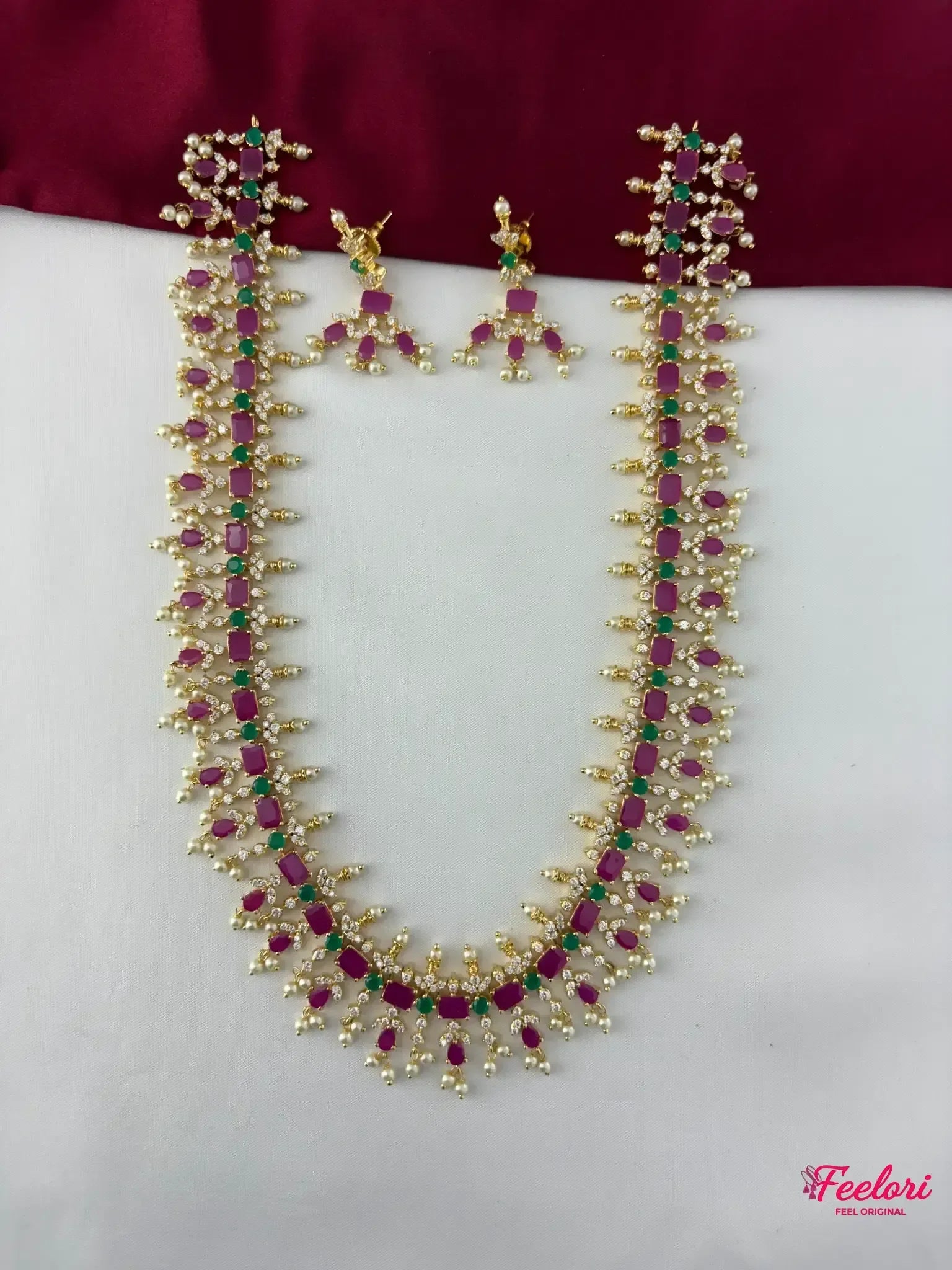 FeelOri Gold Plated Ruby Emerald Pearl Haaram Necklace Set - Front view showcasing the meticulously arranged ruby and emerald stones with delicate pearls outlining the design.