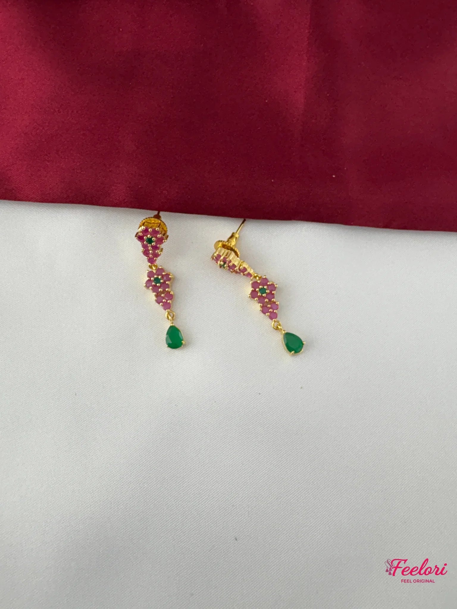 FeelOri Gold Plated Ruby Emerald Vine Earrings - Close-up view of the handcrafted earrings with ruby clusters and a vibrant emerald tear-drop accent.