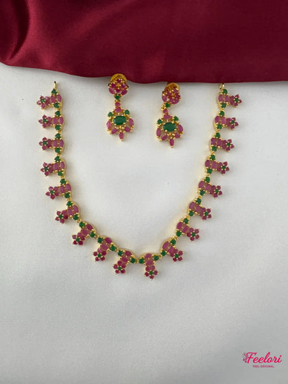 FeelOri Gold Plated Ruby Emerald Earrings - Close-up view showing the intricate vine-like arrangement of Ruby-Tone CZ and emerald stones against a rich gold plating.
