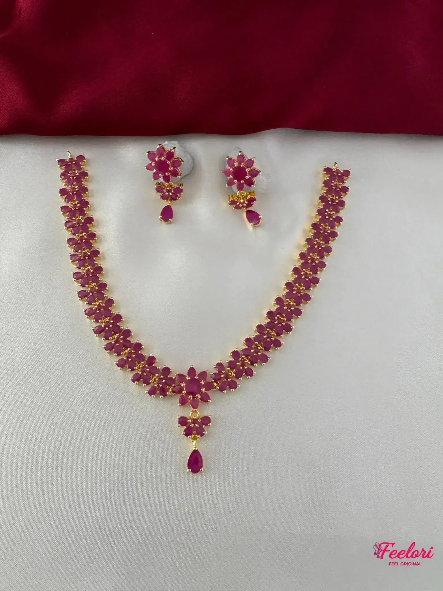 FeelOri Gold Plated Ruby Floral Motif Necklace Set - Front view showcasing the complete choker-style necklace and matching earrings with teardrop details.