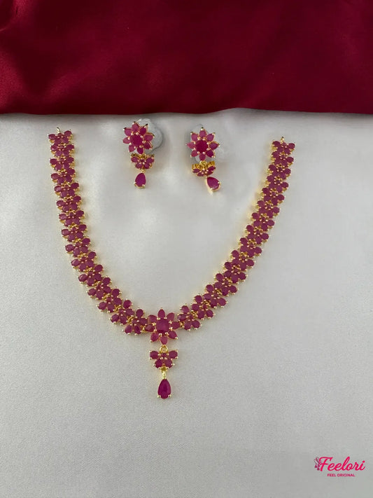 FeelOri Gold Plated Ruby Floral Motif Necklace Set - Front view showcasing the complete choker-style necklace and matching earrings with teardrop details.